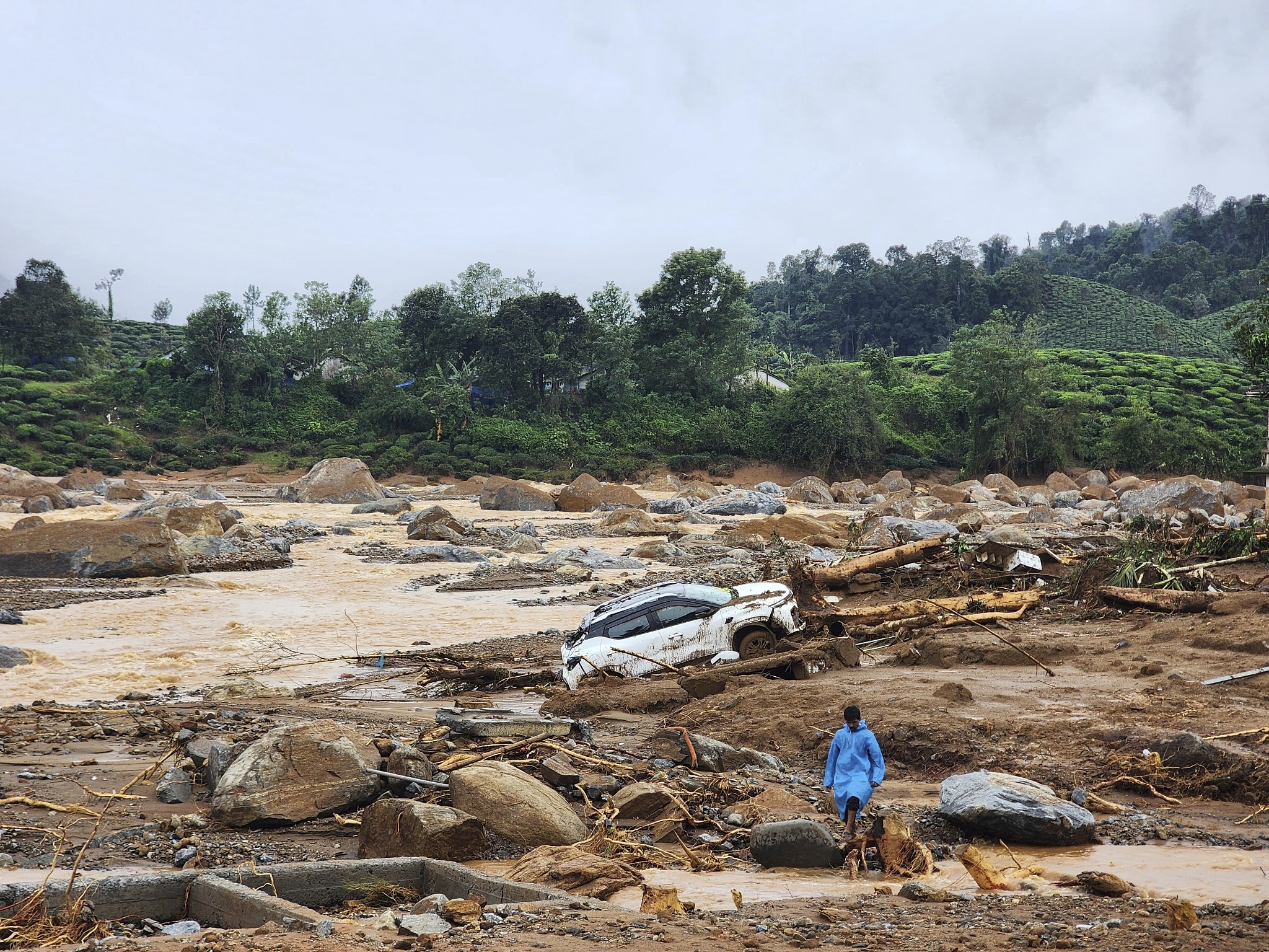 A damaged car lies amid debris after landslides hit hilly villages in Wayanad district, Kerala state, India, July 30, 2024. /CFP