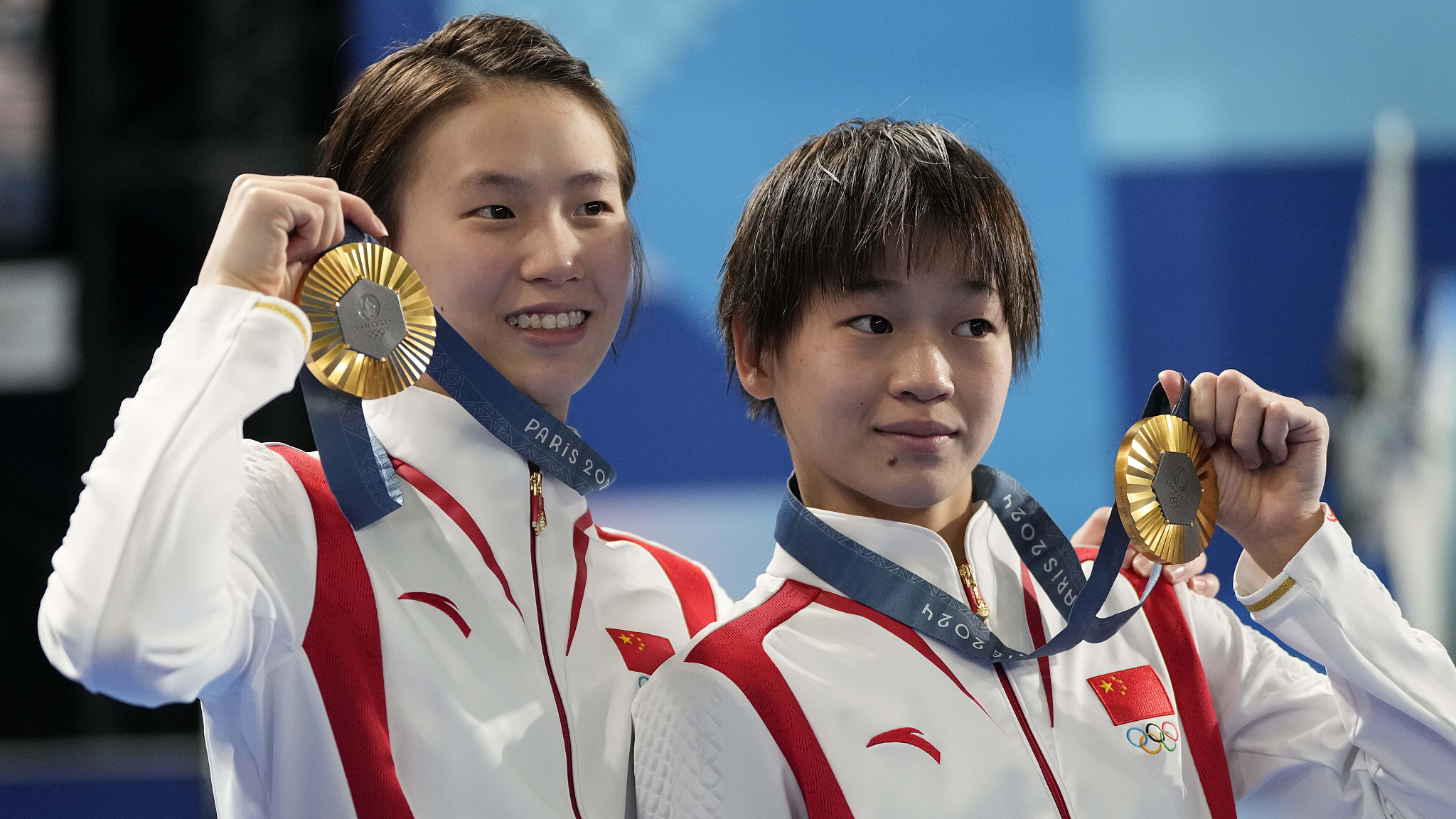 Quan Hongchan (R) and Chen Yuxi of China celebrate winning gold in the women's synchronized 10-meter platform diving final at the 2024 Summer Olympics in Paris, France, July 31, 2024. /CFP