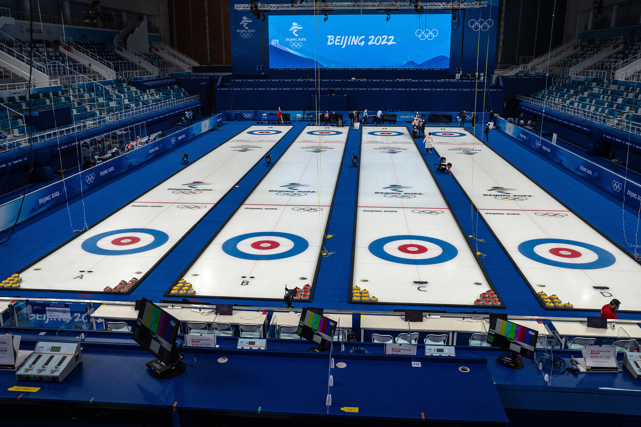 People work on sheets ahead of curling competitions at the National Aquatic Centre in Beijing, January 30, 2022. /CFP