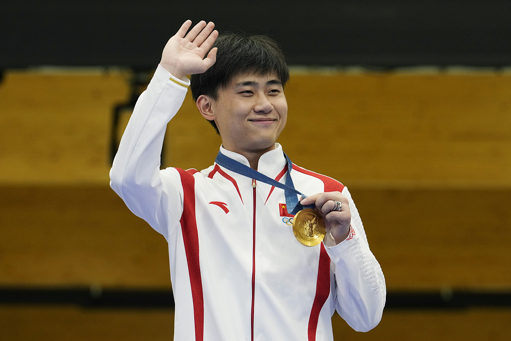 Liu Yukun of China celebrates with his gold medal after winning the men's 50m rifle 3 positions shooting final during the Summer Olympics in Paris, France, August 1, 2024. /CFP