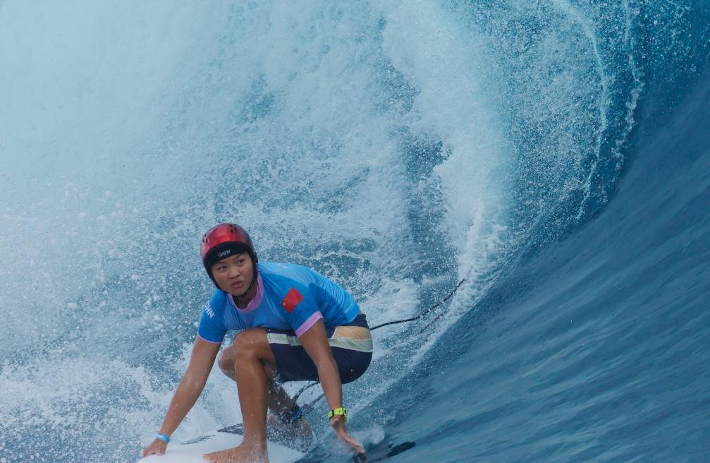 Yang Siqi of China competes during the women's round 1 heat of surfing of the Paris 2024 Olympic Games in Teahupo'o, Tahiti, French Polynesia, July 27, 2024. /Xinhua