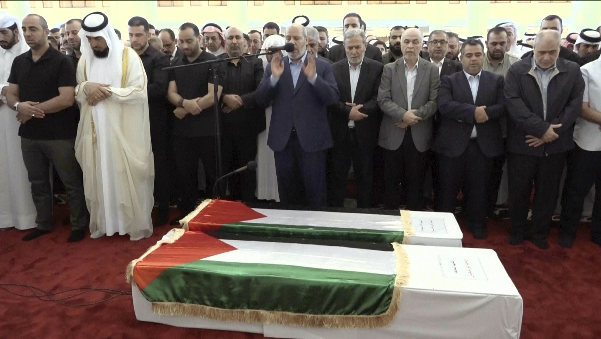 This video grab shows senior Hamas official Khalil al-Hayya, center, praying near the coffin of Hamas leader Ismail Haniyeh and his bodyguard during the funeral prayers in Doha, Qatar, August 2, 2024. /CFP