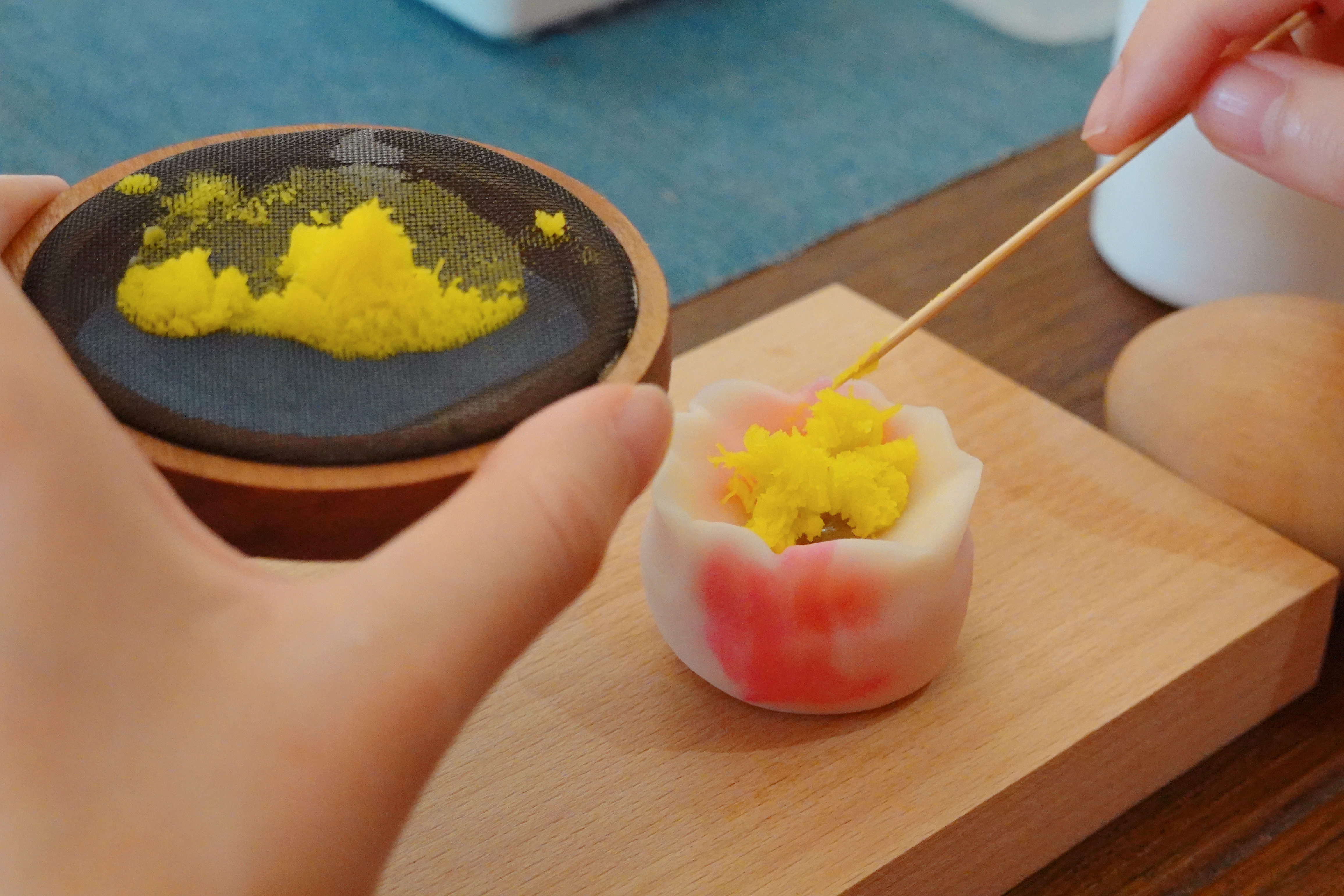 A tangguozi master makes a lotus flower bud-shaped pastry in Nianhuawan, a popular tourist town in Wuxi, Jiangsu Province, on July 21, 2024. /CGTN