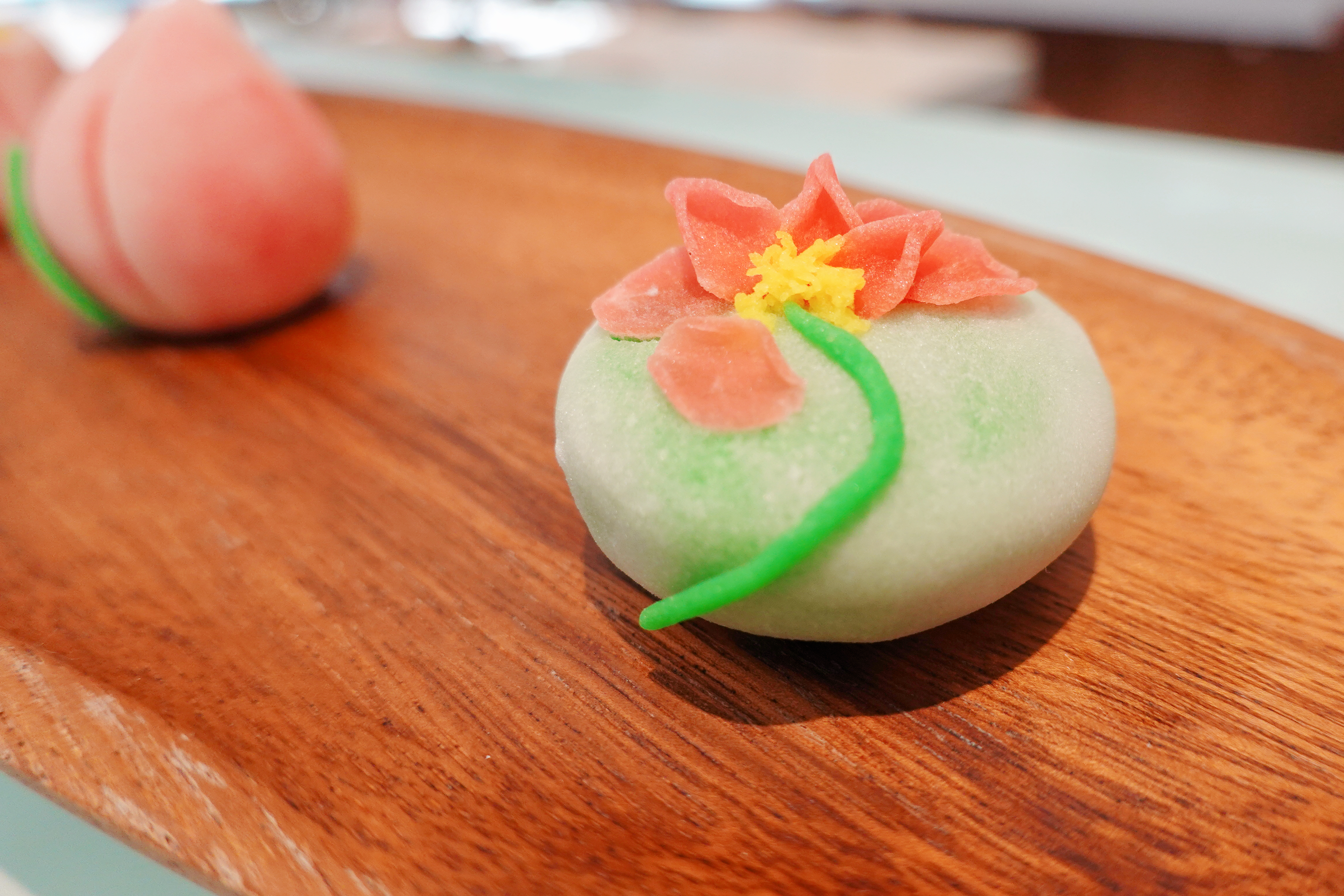 A tangguozi master makes a lotus flower bud-shaped pastry in Nianhuawan, a popular tourist town in Wuxi, Jiangsu Province, on July 21, 2024. /CGTN