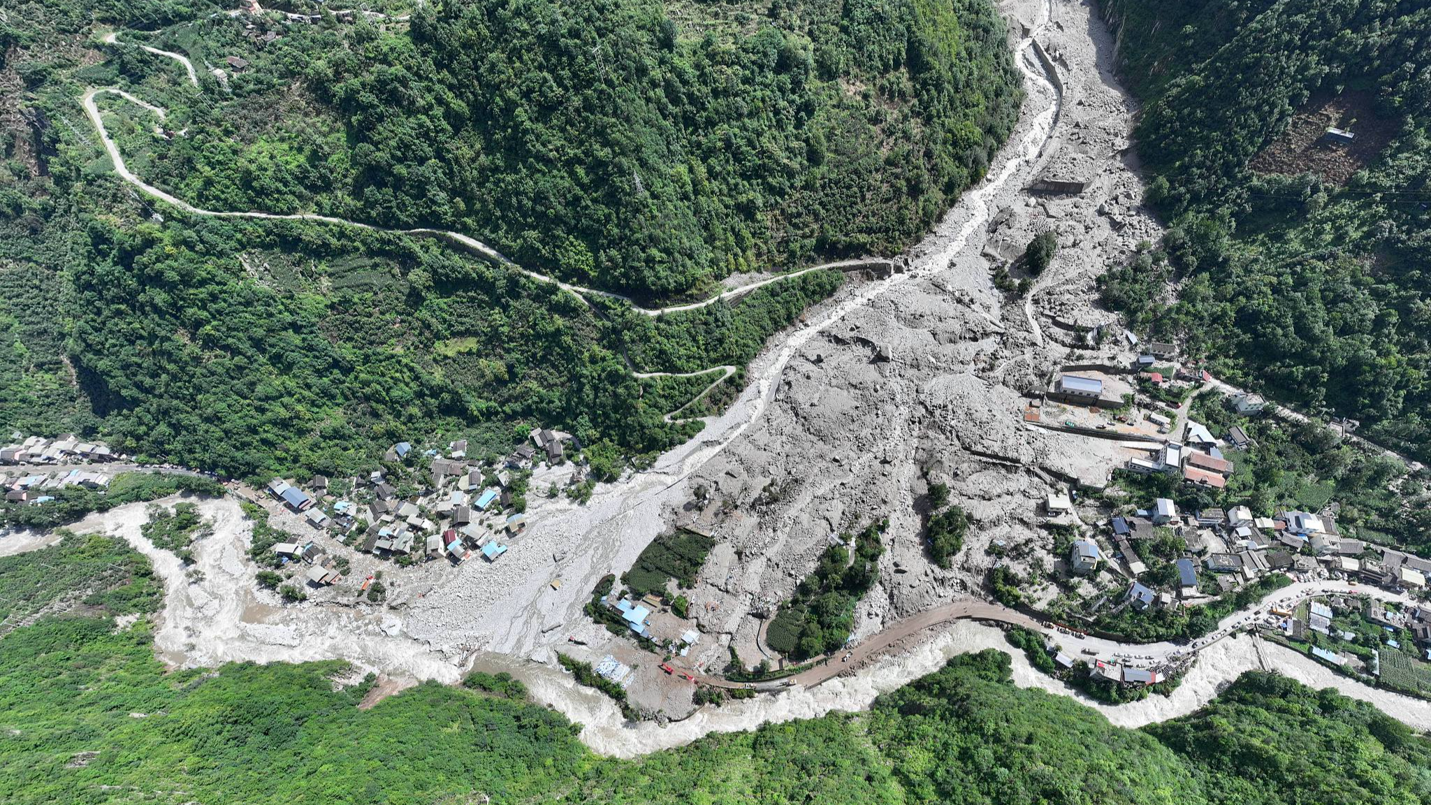 An aerial view shows villages in the wake of a flood and mudslide after heavy rains hit the city of Kangding in southwest China's Sichuan Province, August 3, 2024. /CFP