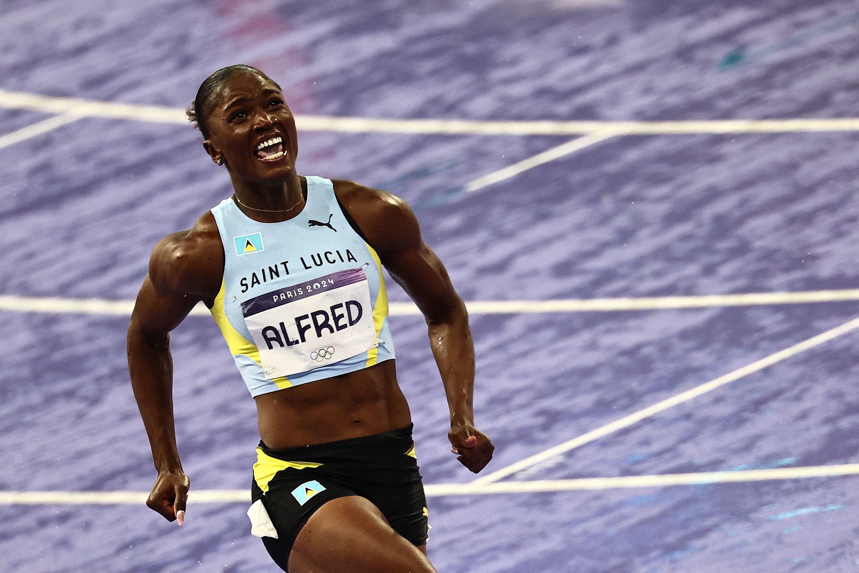 Saint Lucia's Julien Alfred celebrates winning the women's 100m final of the athletics event at the Paris 2024 Olympic Games at Stade de France in Saint-Denis, north of Paris, August 3, 2024. /CFP