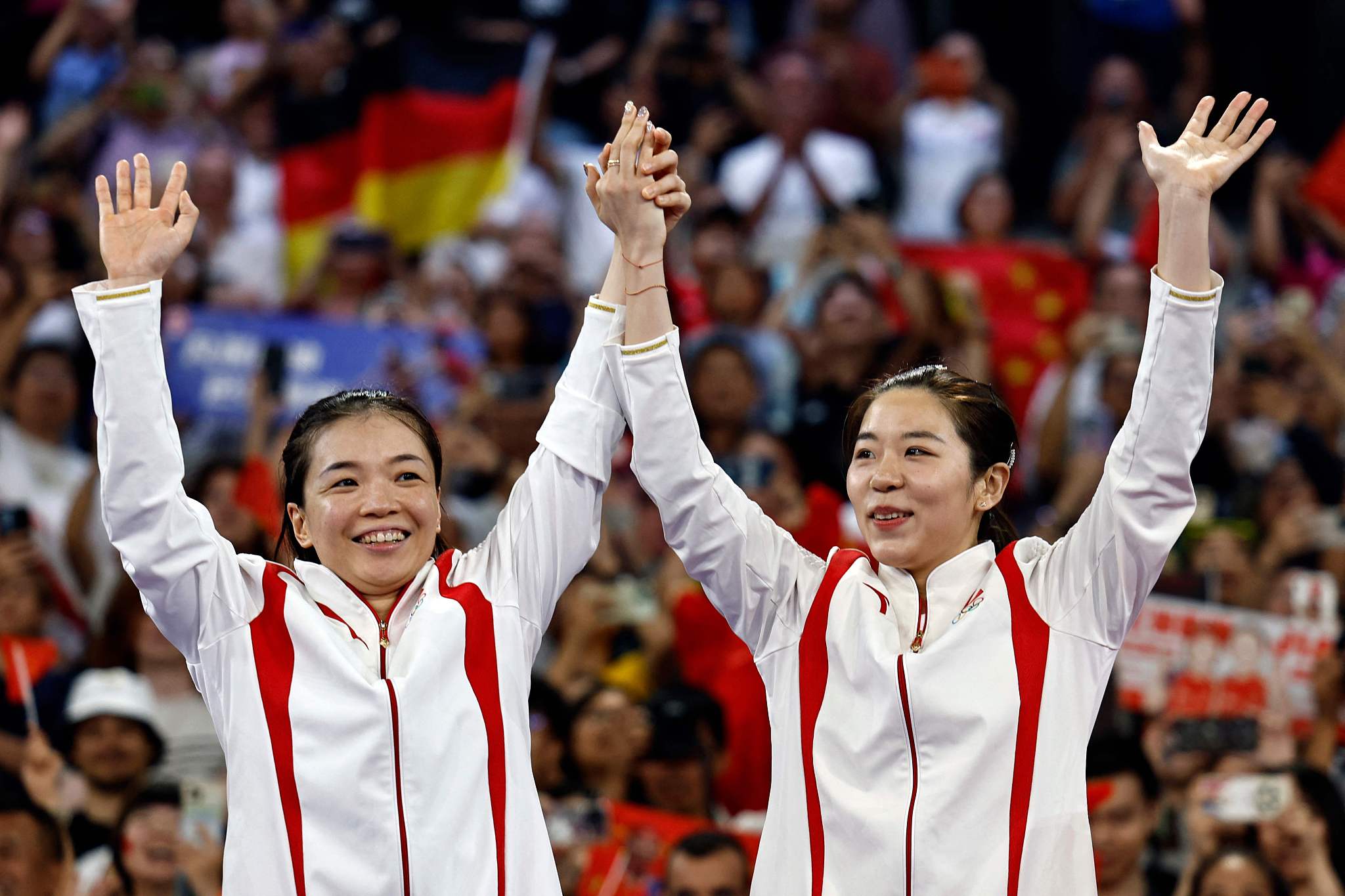 Chen Qingchen (L) and Jia Yifan of China celebrate after winning the women's doubles badminton final at the 2024 Summer Olympics in Paris, France, August 3, 2024. /CFP