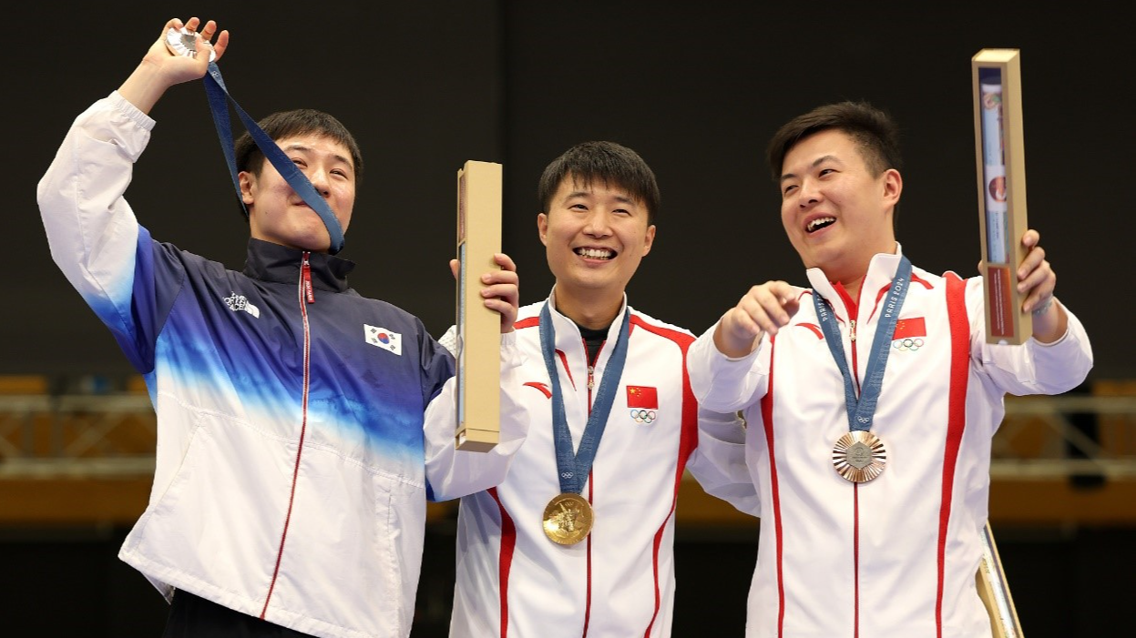 Peraih medali emas Li Yuehong (tengah) dari Tiongkok, peraih medali perak Cho Yeong-jae dari Korea Selatan (kiri) dan peraih medali perunggu Wang Xinjie (kanan) dari Tiongkok merayakan kemenangan di podium selama upacara penyerahan medali final nomor tembak pistol cepat 25 meter putra di Olimpiade Musim Panas 2024 di Chateauroux, Prancis, 5 Agustus 2024. /CFP