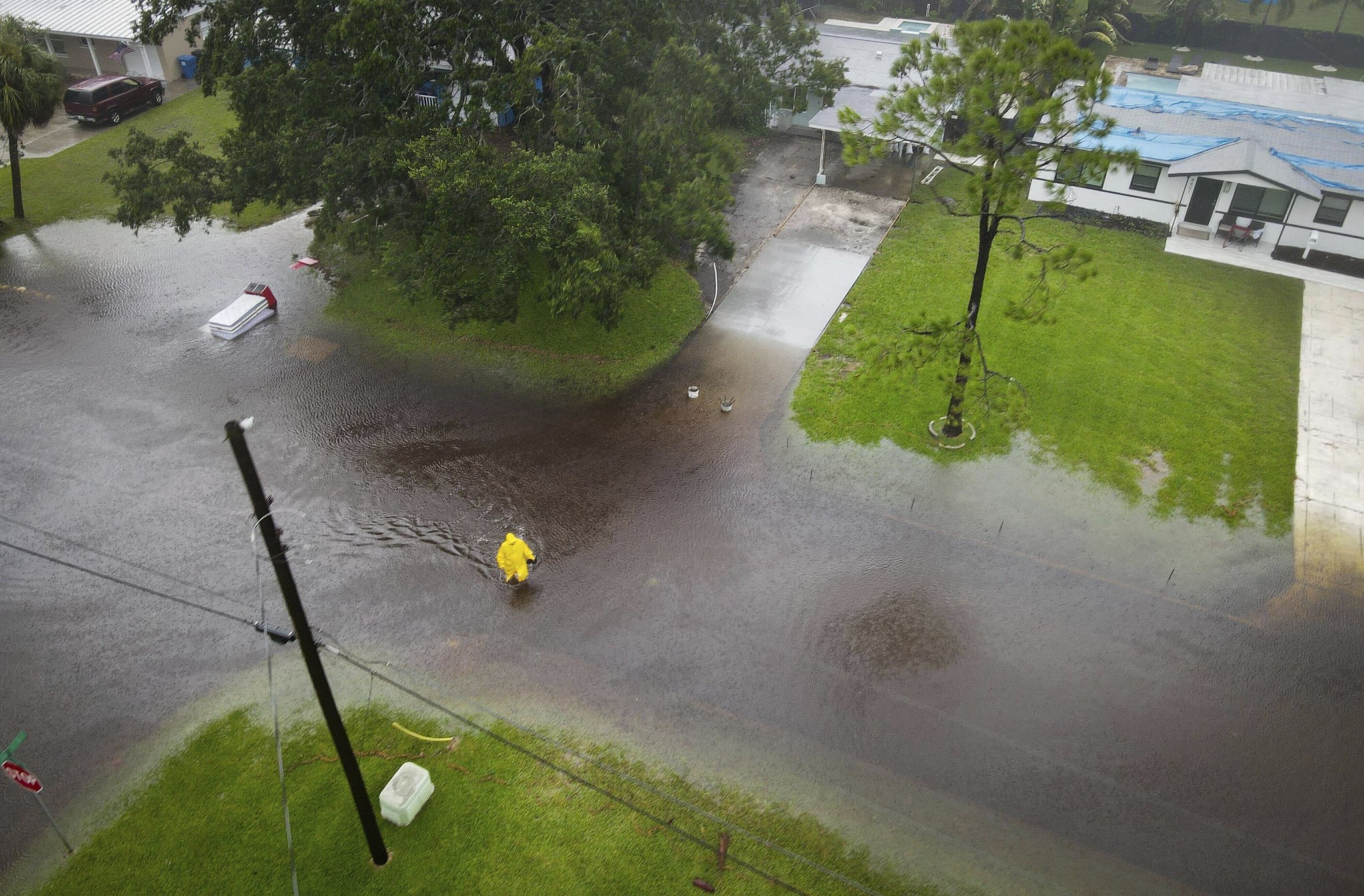 A pedestrian wades across a flooded street as a result of Tropical Storm Debby in the Shore Acres area of St. Petersburg, U.S., August 4, 2024. /CFP