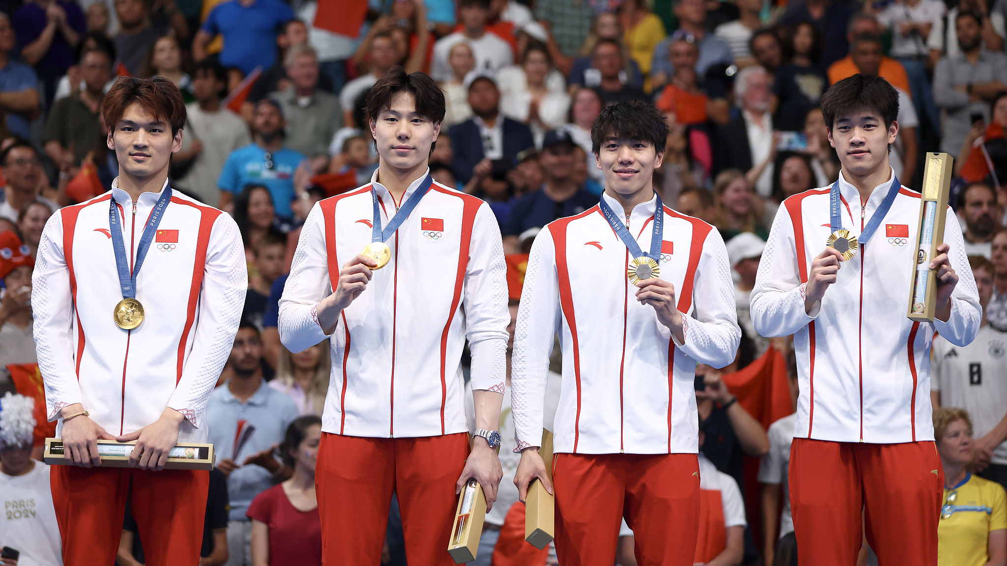 L-R: Gold medalists Xu Jiayu, Qin Haiyang, Sun Jiajun and Pan Zhanle of Team China pose on the podium during the medal ceremony of the men's 4x100m medley relay final of the Paris Olympic Games, August 4, 2024. /CFP