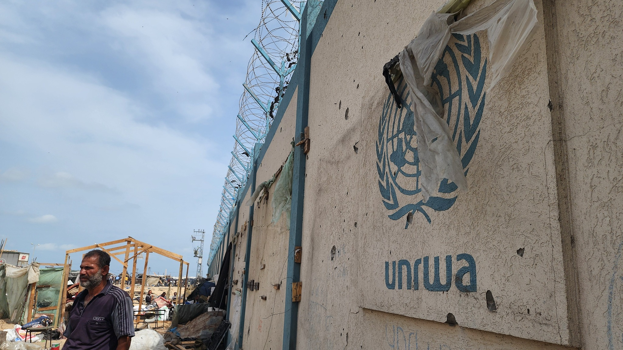 Palestinians examine the destroyed makeshift tents and collect usable items after Israeli army attacks on tents of displaced Palestinians living near the United Nations Relief and Works Agency for Palestine Refugees (UNRWA) warehouses in Rafah, Gaza, May 28, 2024. /CFP