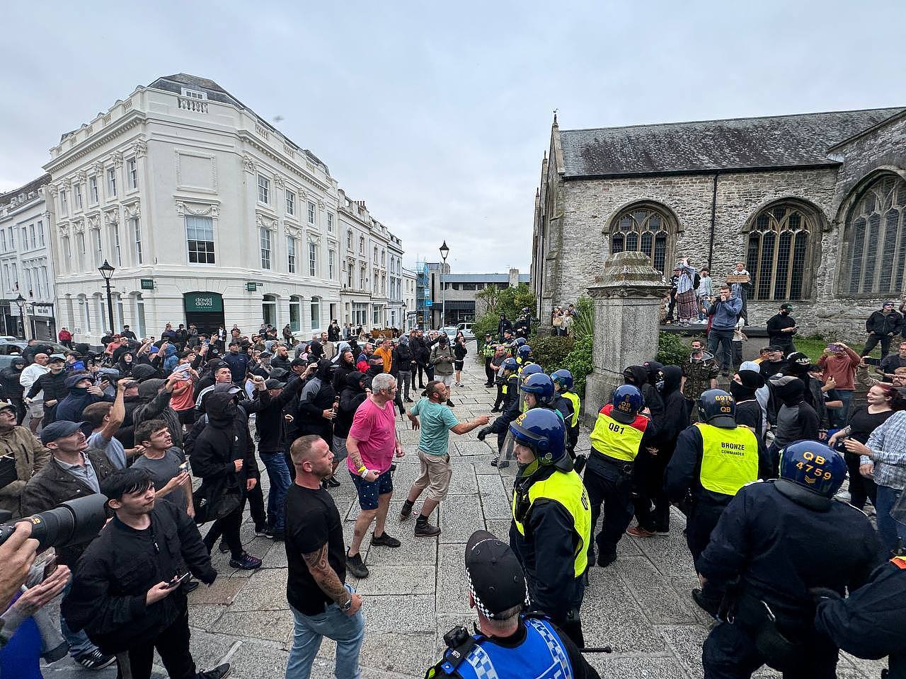 Police officers intervene as anti-racism activists gather at Guildhall Square to face off far-right protesters after they announce a protest in Plymouth, United Kingdom, August 5, 2024. /CFP