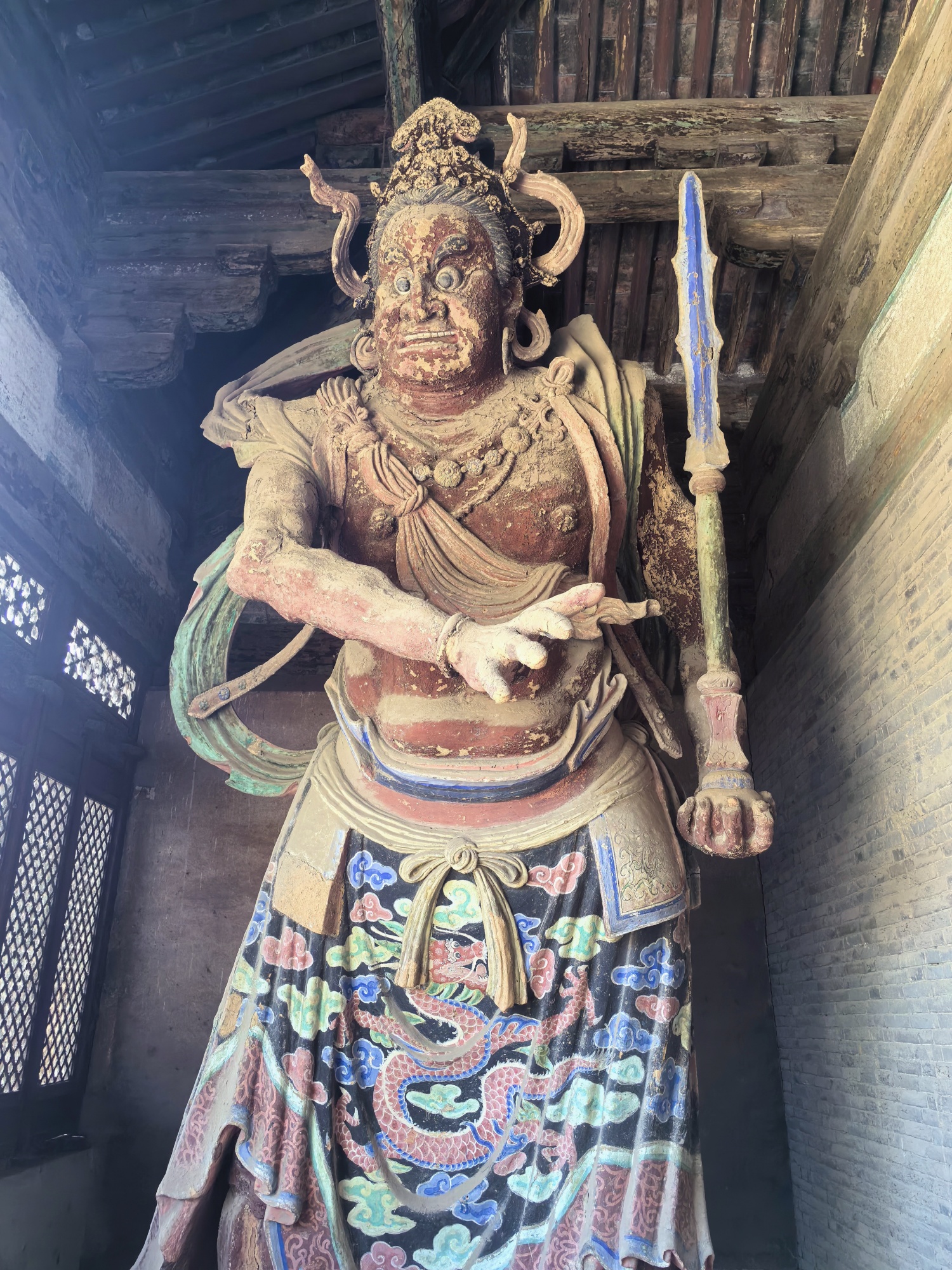 A clay sculpture stands at the front gate of the Dule Temple in north China's Tianjin on July 28, 2024. /CGTN