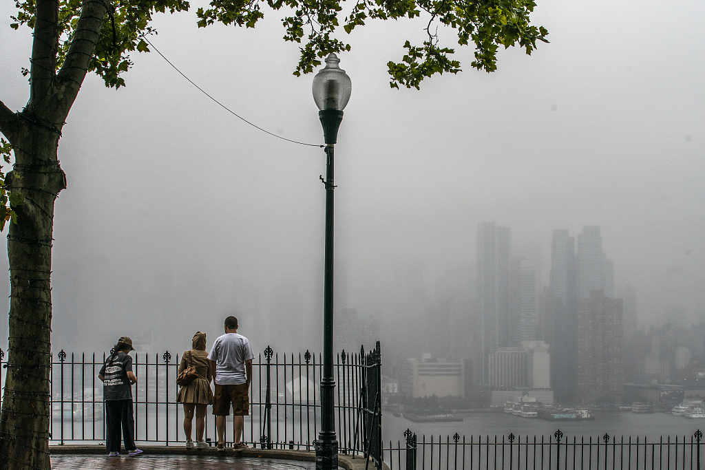 People watch the fog covering the skyline during a rainy day in New York City, U.S., August 8, 2024. /CFP