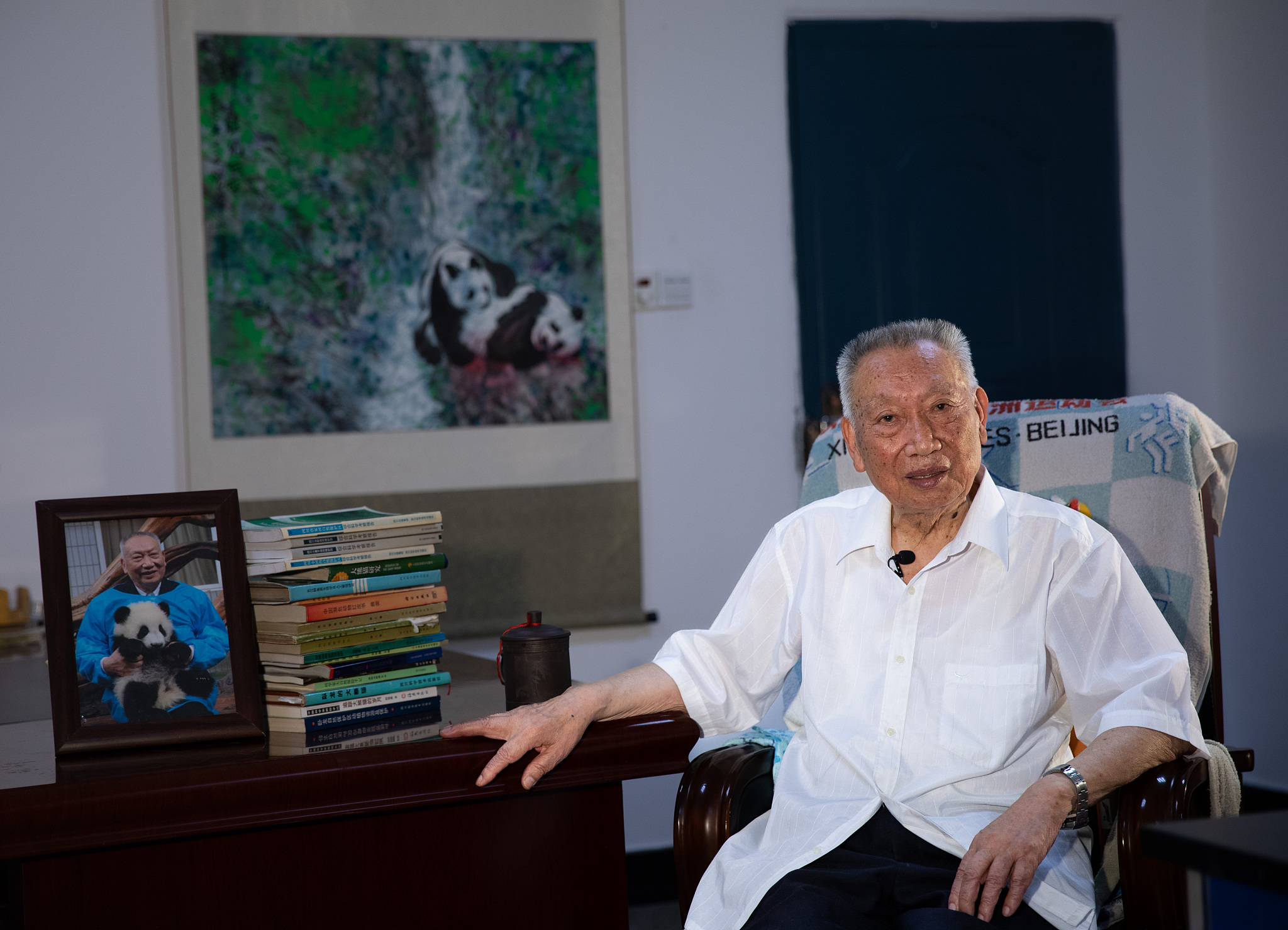 Hu Jinchu, China's foremost expert in giant panda research and conservation, is interviewed at the Institute of Rare Flora and Fauna at China West Normal University, June 21, 2017. /CFP