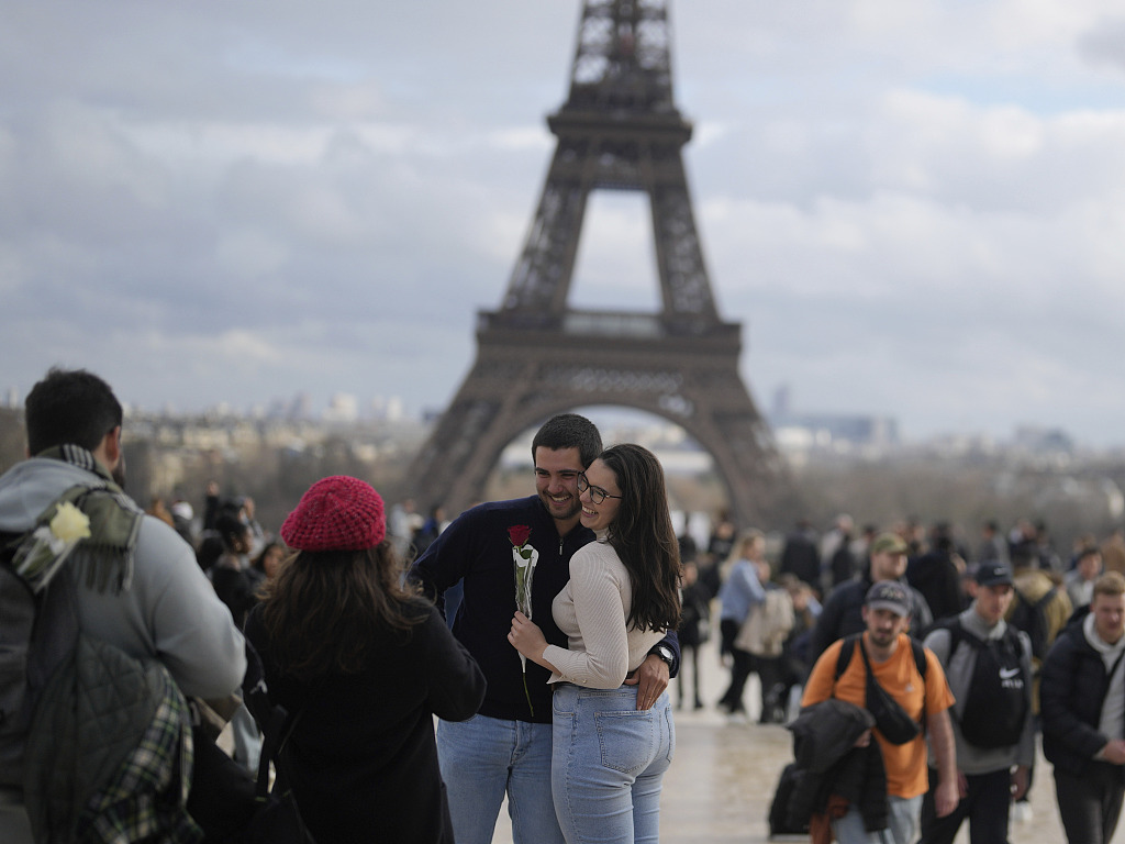 A couple poses for a photographer in front of the Eiffel Tower in Paris, France on Valentine's Day, February 14, 2024. /CFP