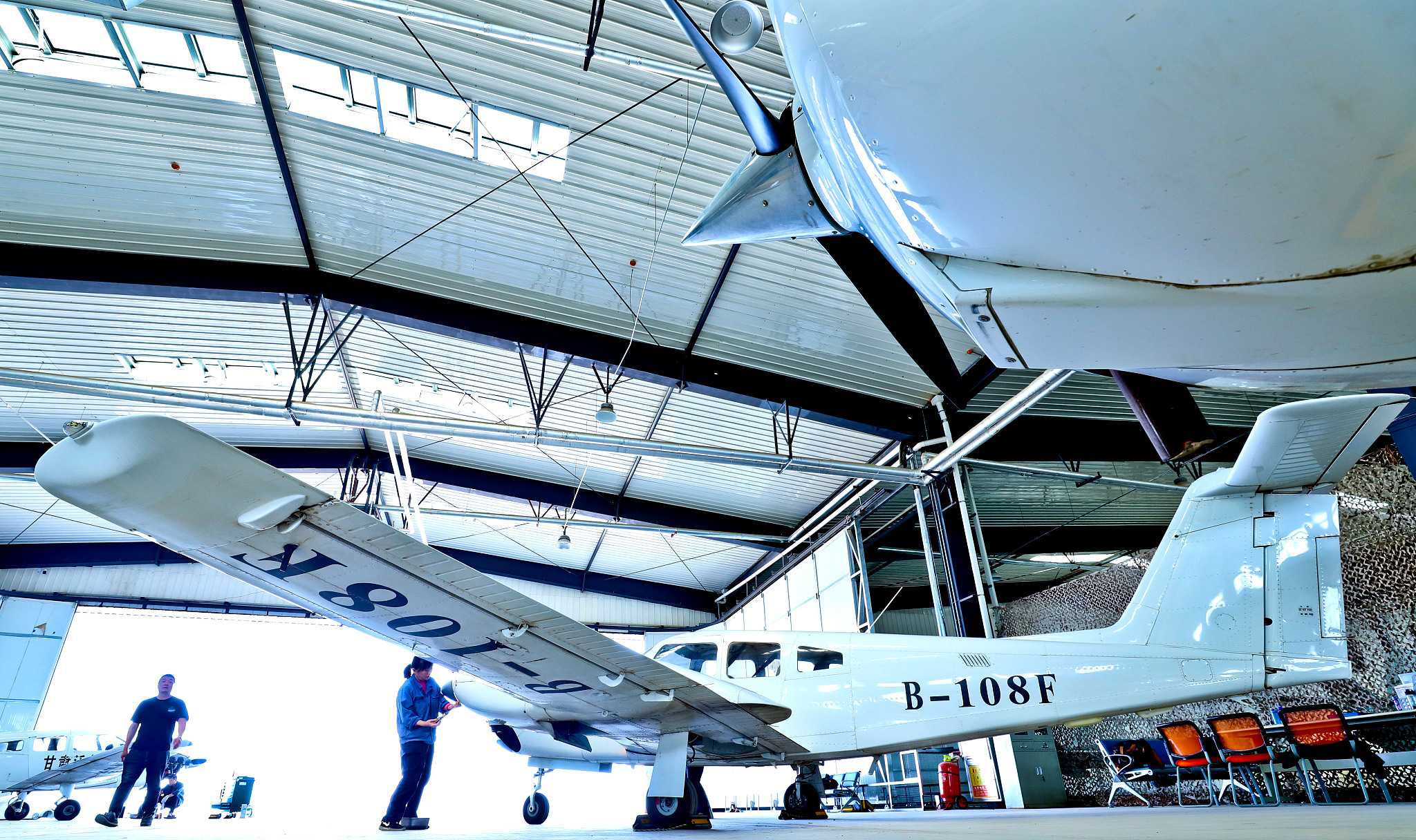 Technicians perform inspections, maintenance and repairs on a light aircraft in Zhangye City, northwest China's Gansu Province, July 4, 2024. /CFP