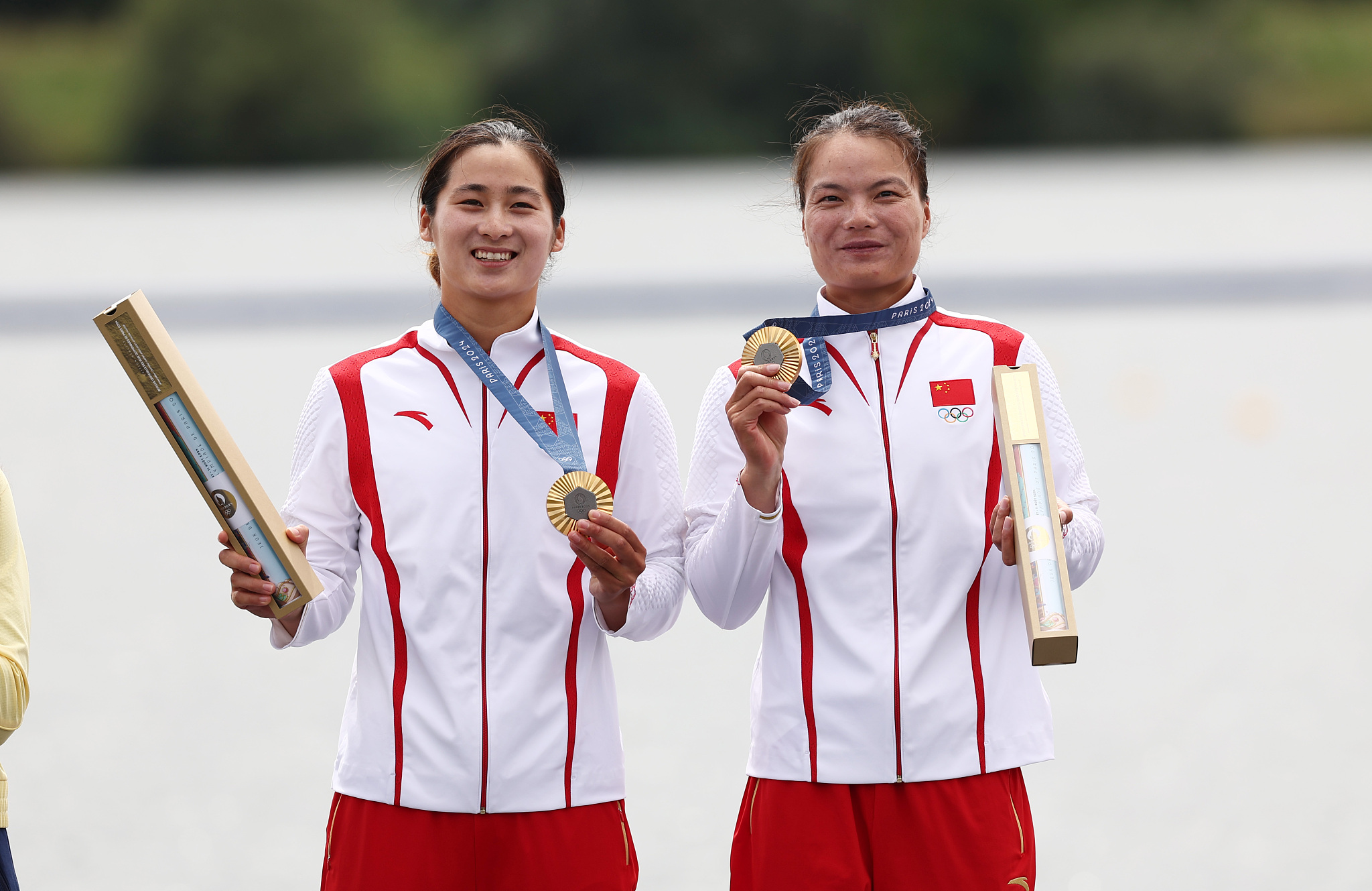 Sun Mengya (L) and Xu Shixiao of China celebrate winning the women's canoe double 500-meter gold at the 2024 Summer Olympics in Paris, France, August 9, 2024. /CFP