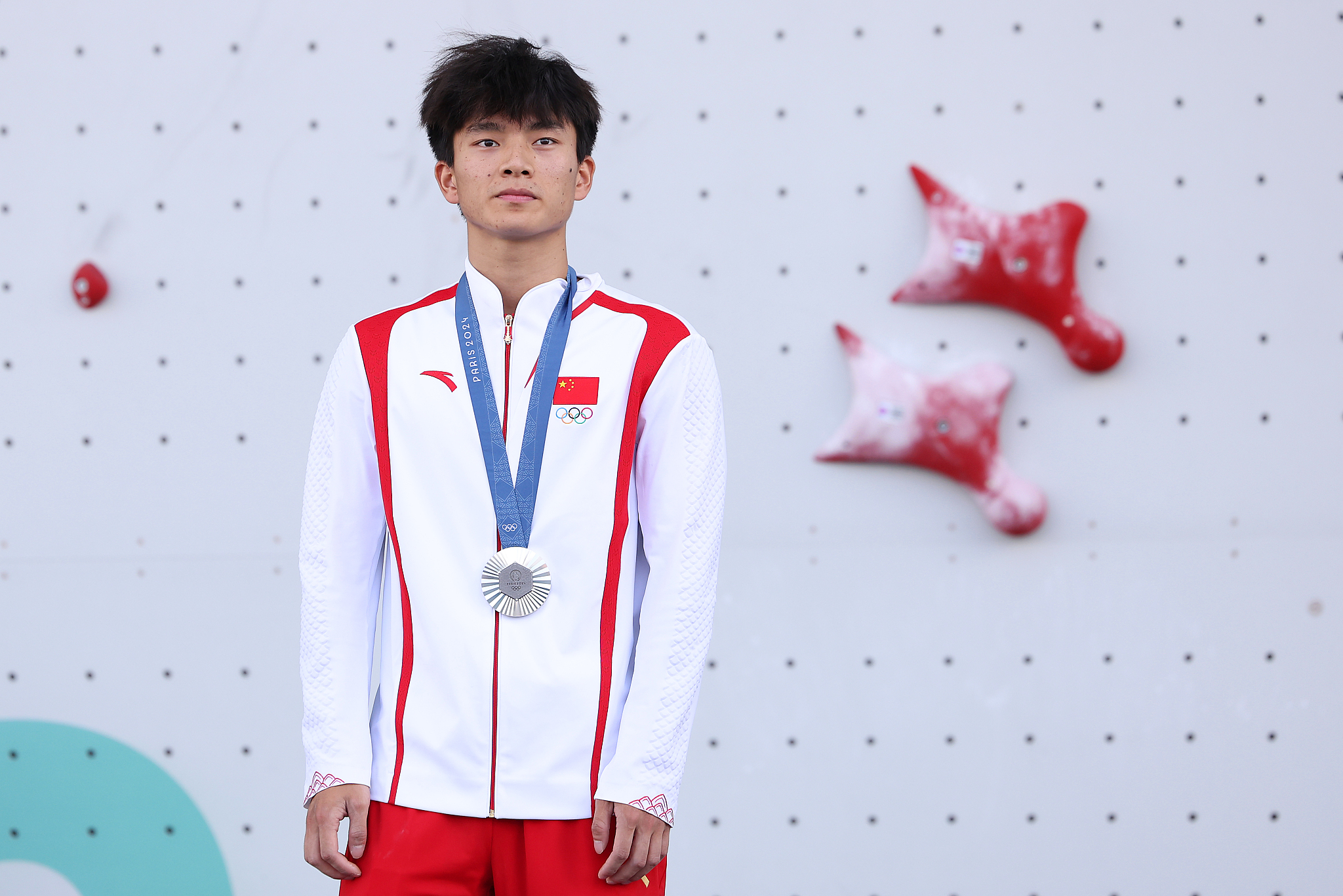 Wu Peng of China celebrates after securing the sport climbing men's speed silver medal at the 2024 Summer Olympics in Paris, France, August 8, 2024. /CFP