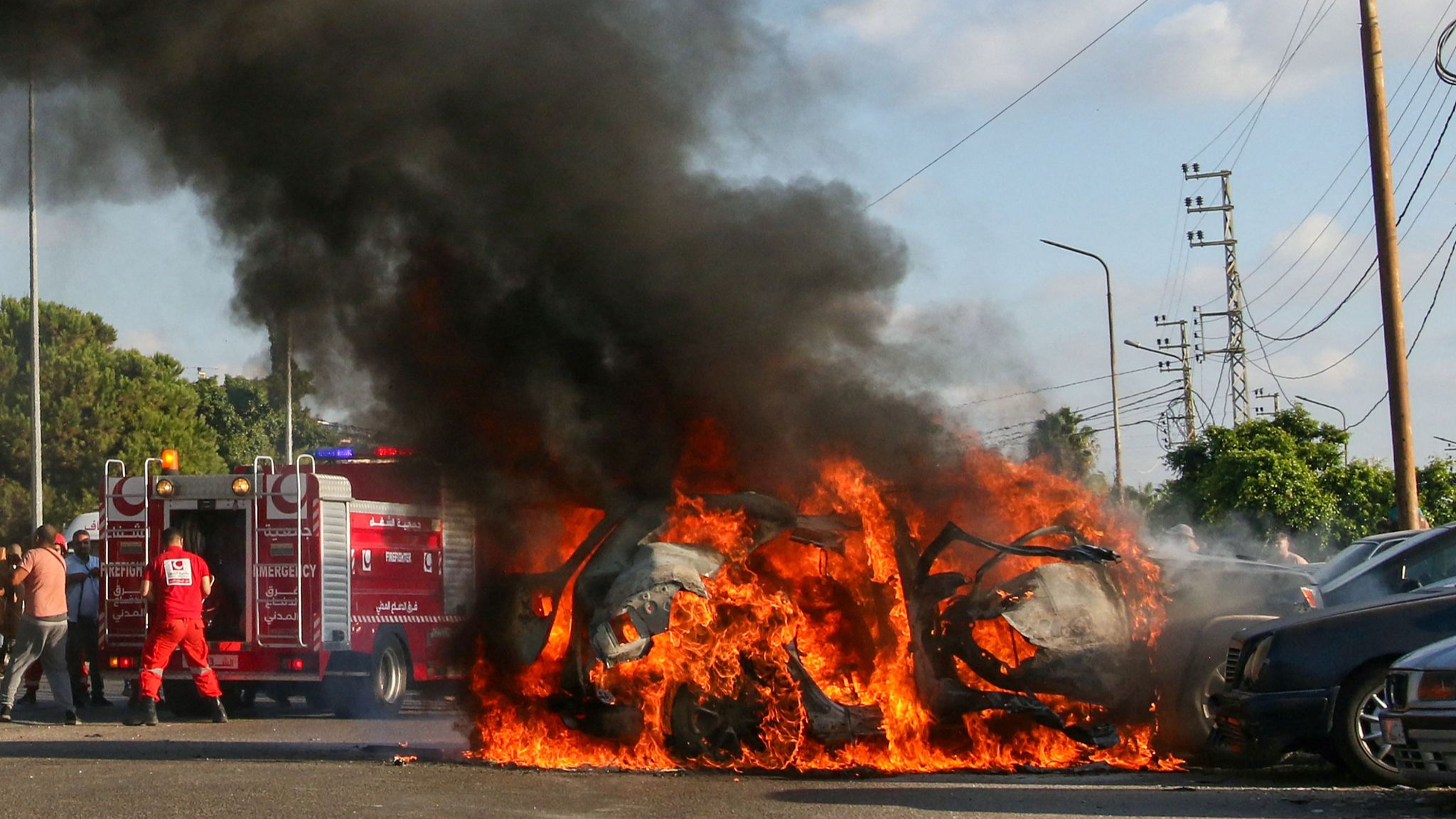 Firefighters arrive as a car burns following an Israeli strike in the southern Lebanese city of Sidon, August 9, 2024. /CFP