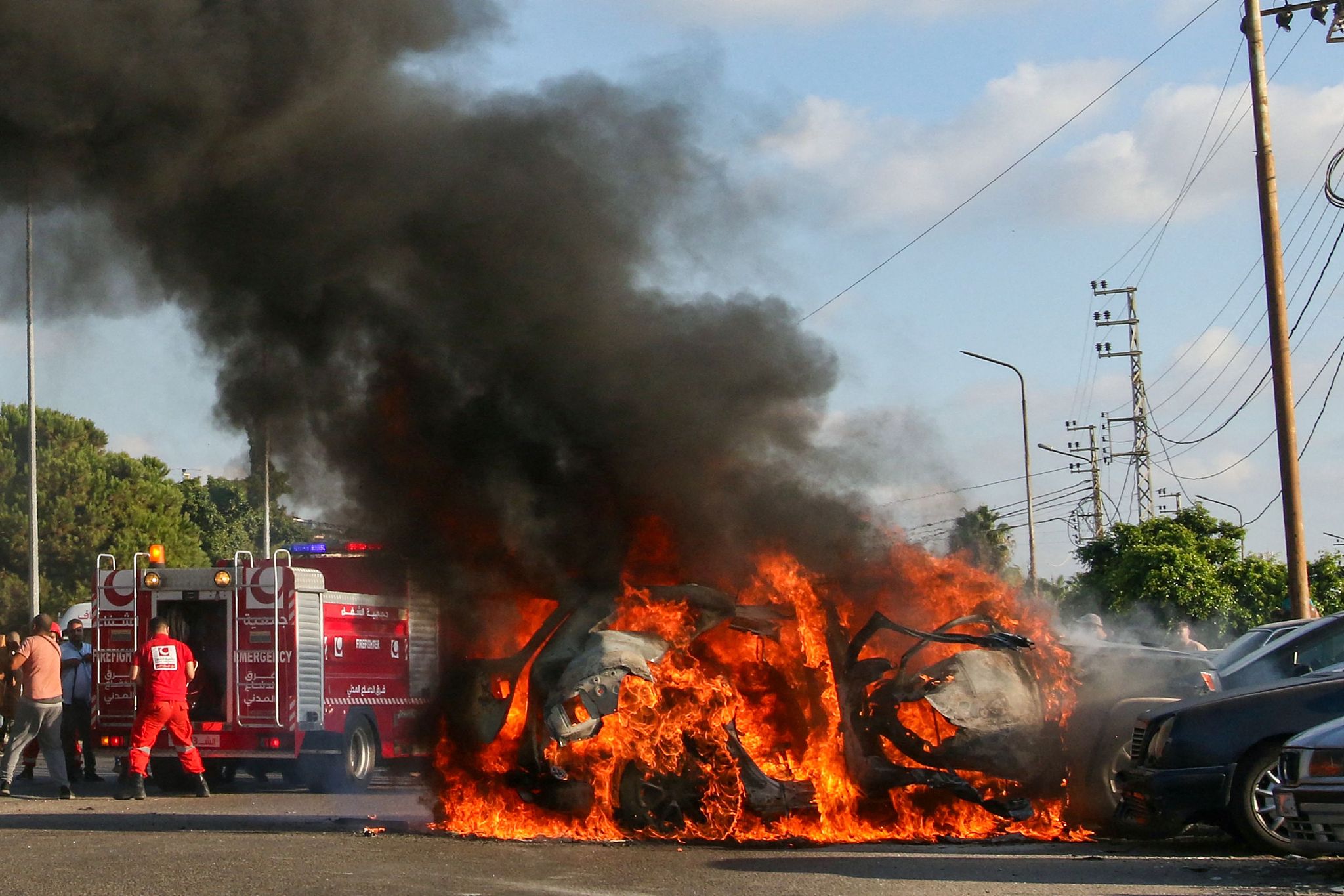 Firefighters arrive as a car burns following an Israeli strike in the southern Lebanese city of Sidon, August 9, 2024. /CFP
