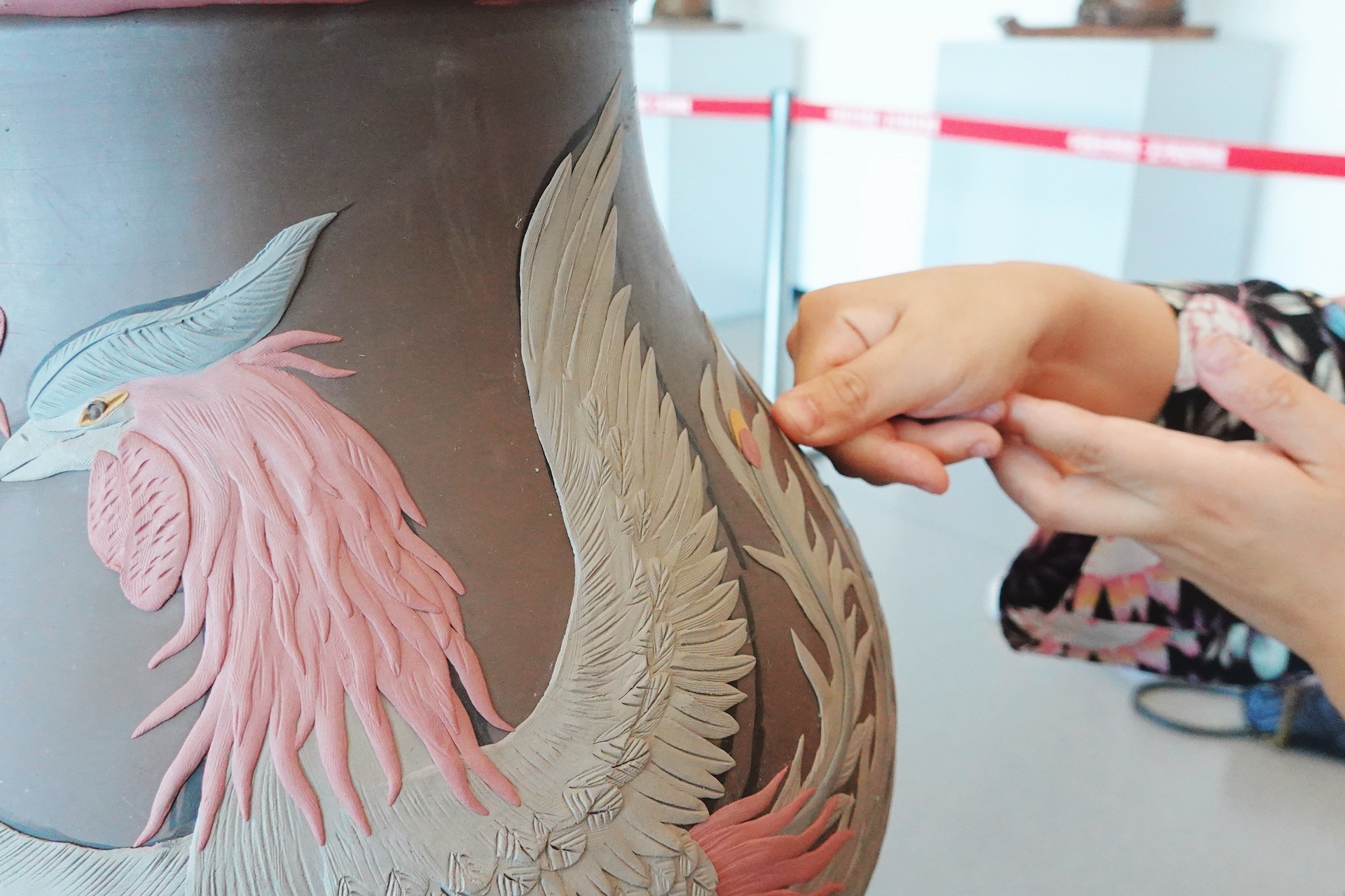 An artist demonstrates Jun-glazed pottery craftsmanship with her thumb and flexible finger work to emboss designs on a pottery surface at the Yixing Ceramic Museum in Wuxi, Jiangsu Province. /CGTN