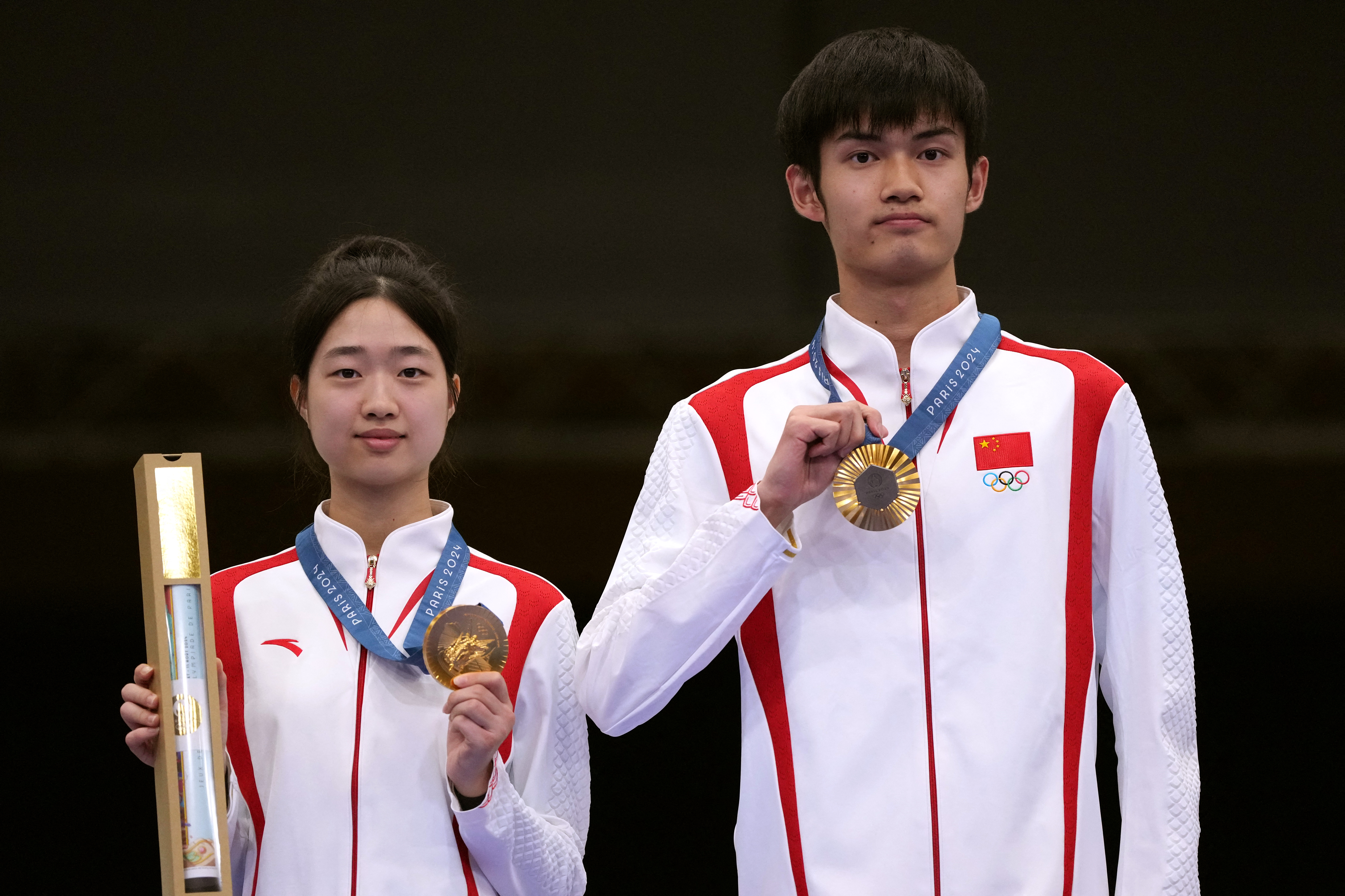 Chinese teenage duo Huang Yuting and Sheng Lihao claim the first gold medal of the Paris Olympics in the 10m air rifle mixed team event in Paris, France, July 27, 2024. /IC