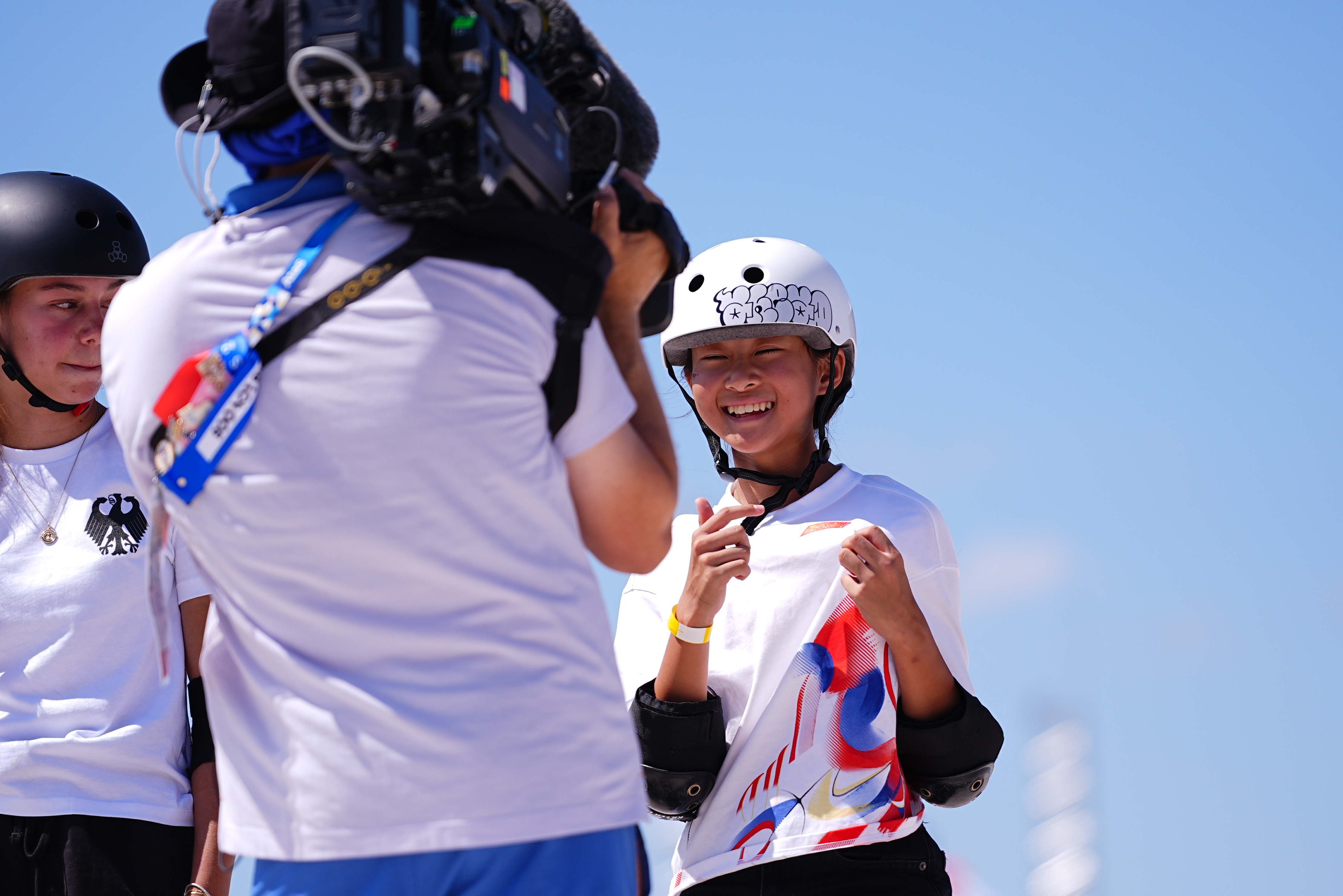 Young skater Zheng Haohao points to the Chinese national flag with a bright smile at the Paris 2024 Olympic Games in Paris, France, August 6, 2024. /IC