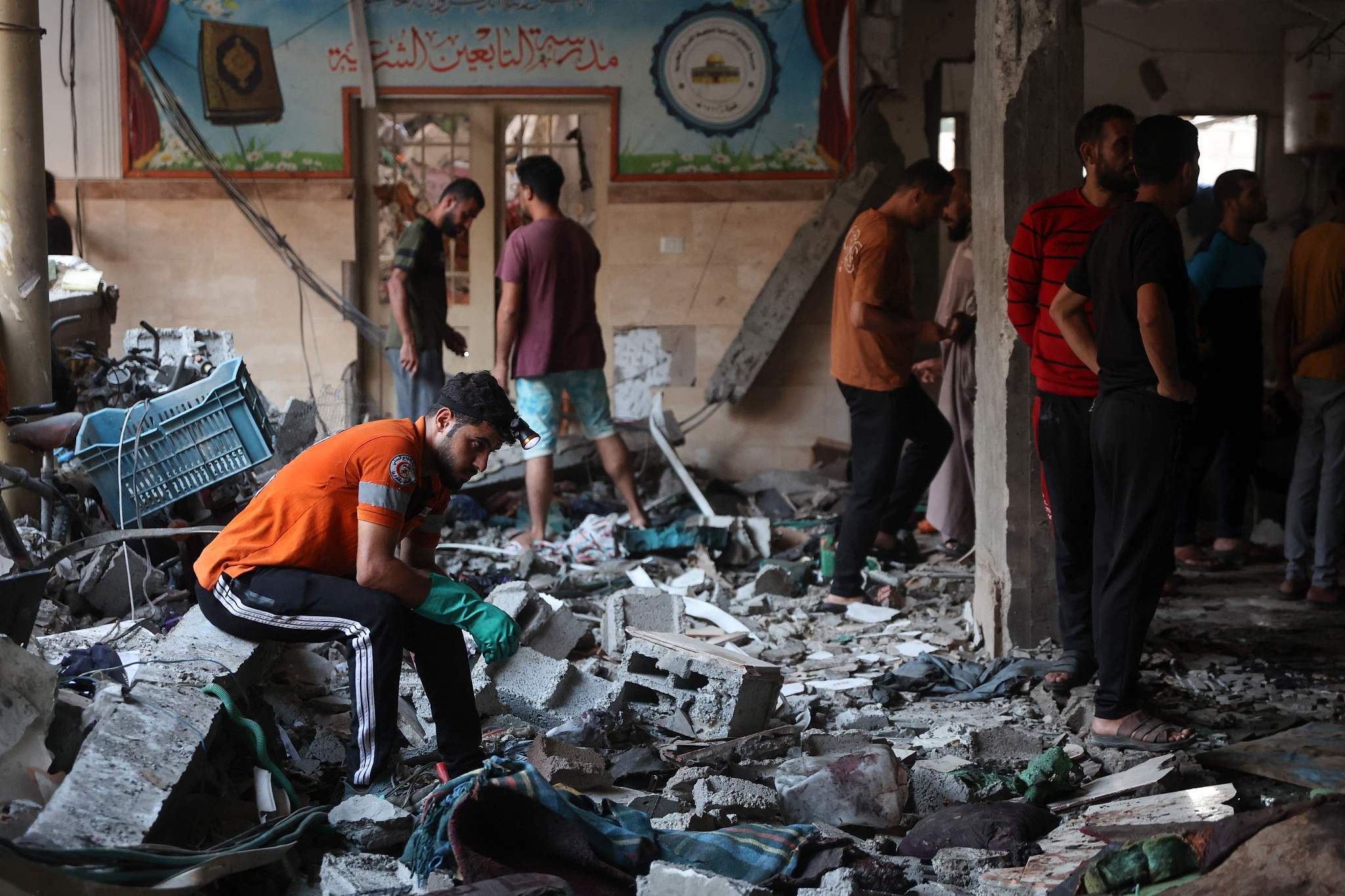 People check the damage inside a school used as a temporary shelter for displaced Palestinians in Gaza City, following an Israeli strike, August 10, 2024. /CFP