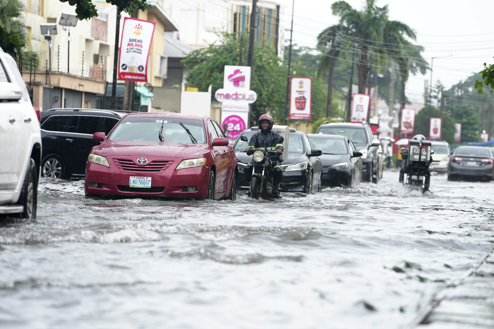 Cars drive on a flooded streets after a heavy downpour in Lagos, Nigeria, July 10, 2024. /CFP