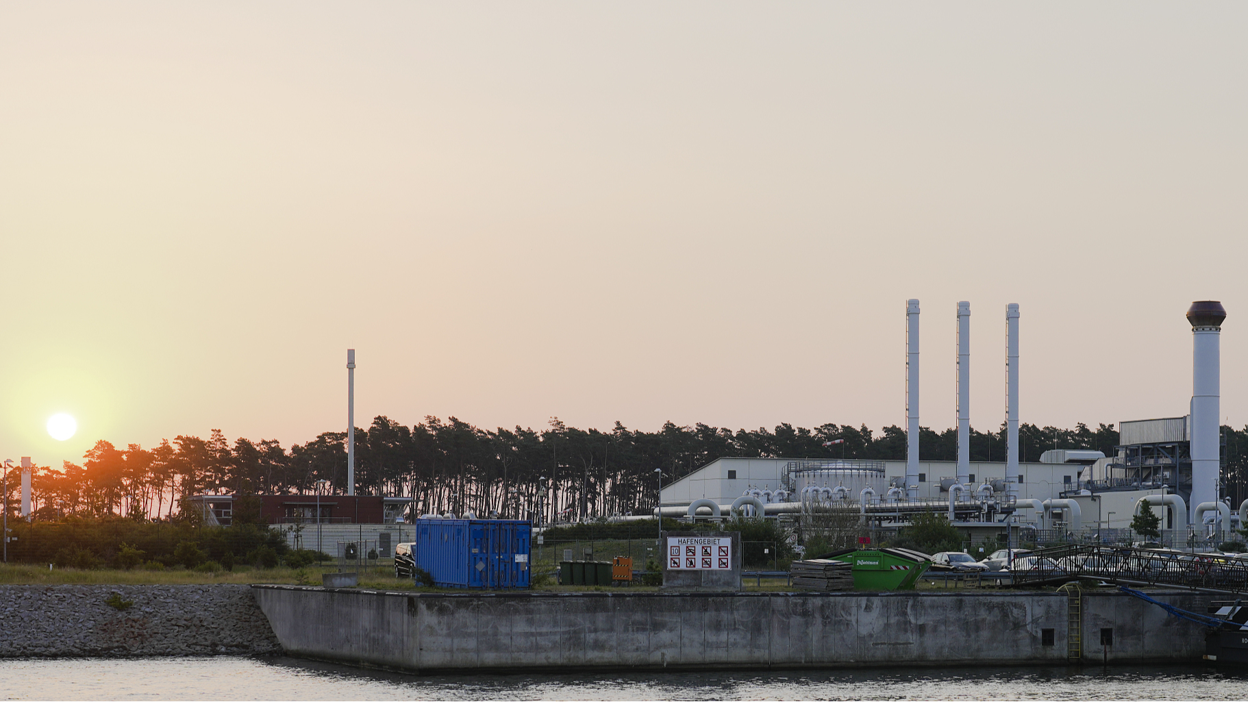 The sun rises behind the landfall facility of the Nord Stream 1 Baltic Sea pipeline and the transfer station of the OPAL gas pipeline, the Baltic Sea Pipeline Link, in Lubmin, Germany, July 21, 2022. /CFP