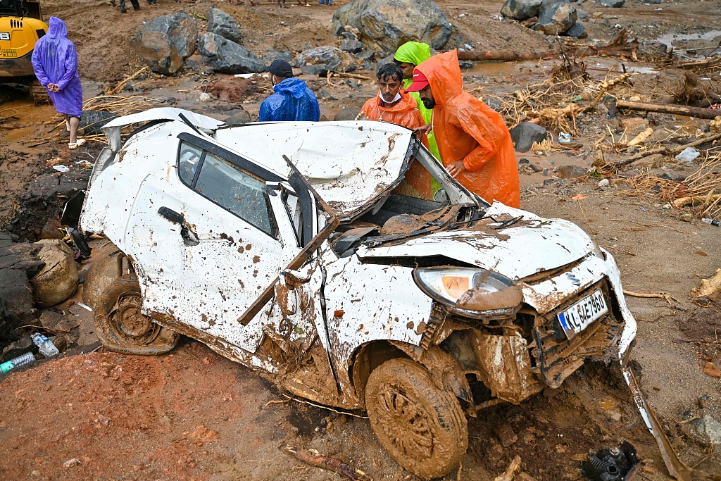 Rescuers check a damaged vehicle after the landslides in Wayanad District, Kerala State, India, August 1, 2024. /CFP 