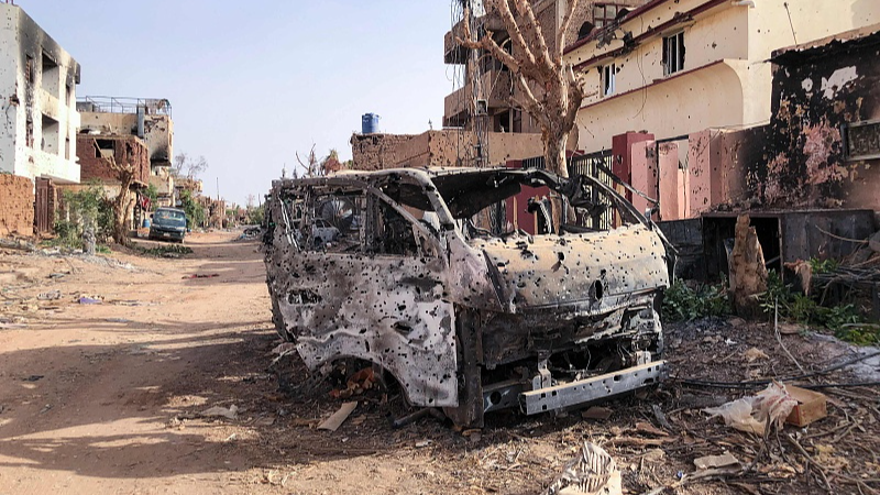 A burnt vehicle in front of damaged shop in Omdurman, Sudan, May 30, 2024. /CFP