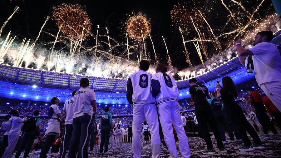 Athletes enjoy the fireworks show during the closing ceremony of the Paris 2024 Olympic Games in Paris, France, August 11, 2024. /Xinhua