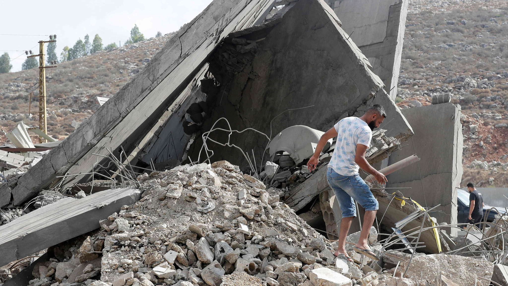 A man inspects the damage to a building after an Israeli strike in the southern town of Kfour, Nabatieh district, Lebanon, August 17, 2024. /CFP