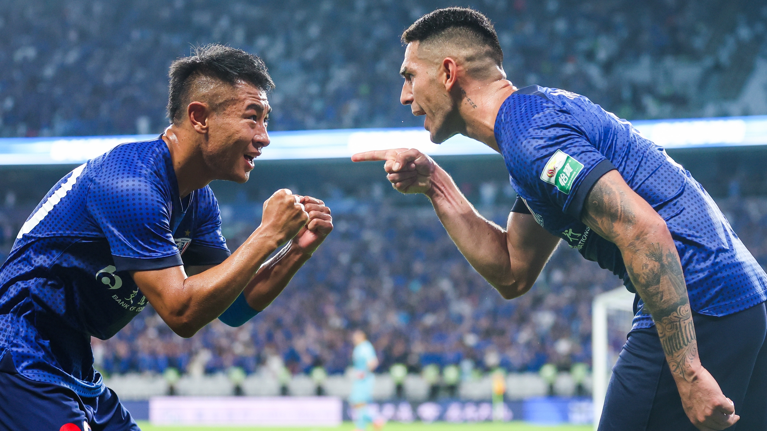 Andre Luis (R) celebrates with Shanghai Shenhua teammate Yu Hanchao during a Chinese Super League match against Shanghai Port, Shanghai, China, August 17, 2024. / IC Photo