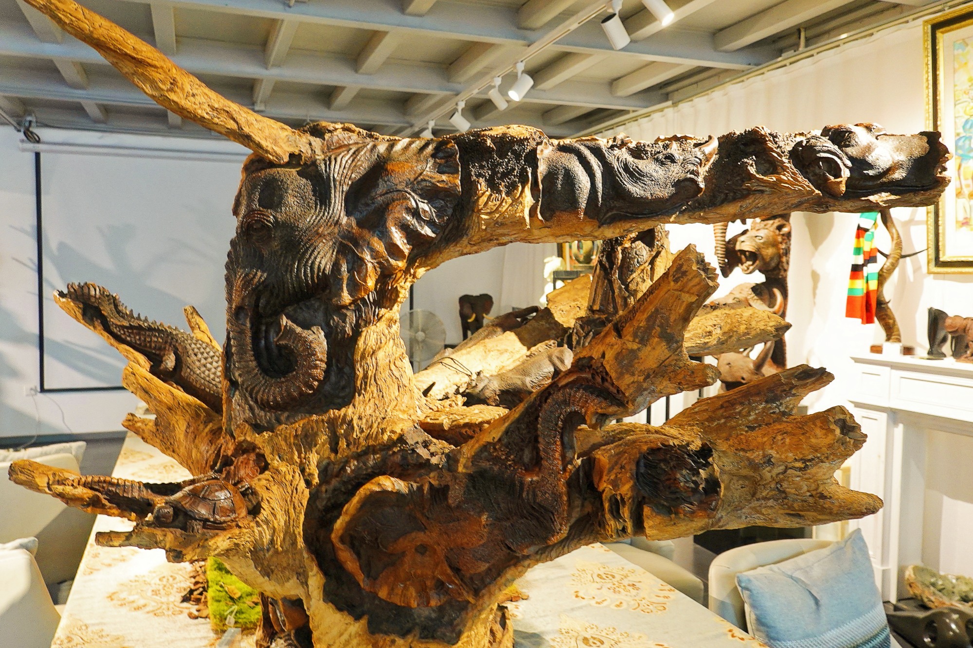 A table carved from a padauk tree root is seen at the Apex African Art Gallery in Beijing on August 7, 2024. /CGTN
