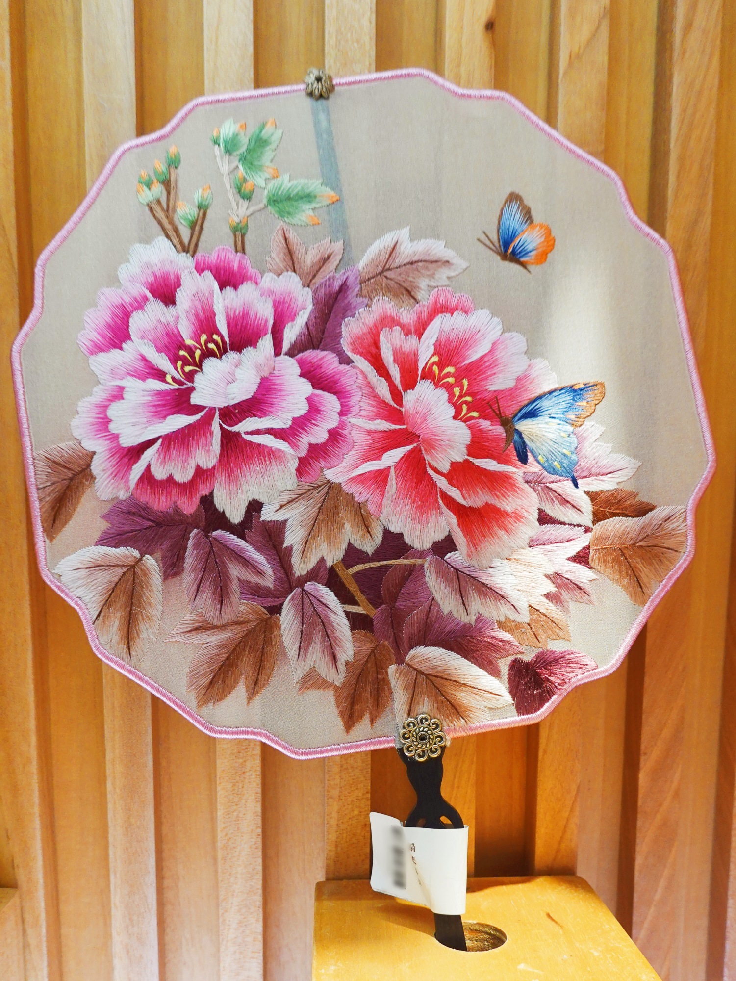 A silk fan featuring Suzhou embroidery is seen on display at Nianhuawan, a popular tourist town in Wuxi, Jiangsu Province, on July 21, 2024. /CGTN