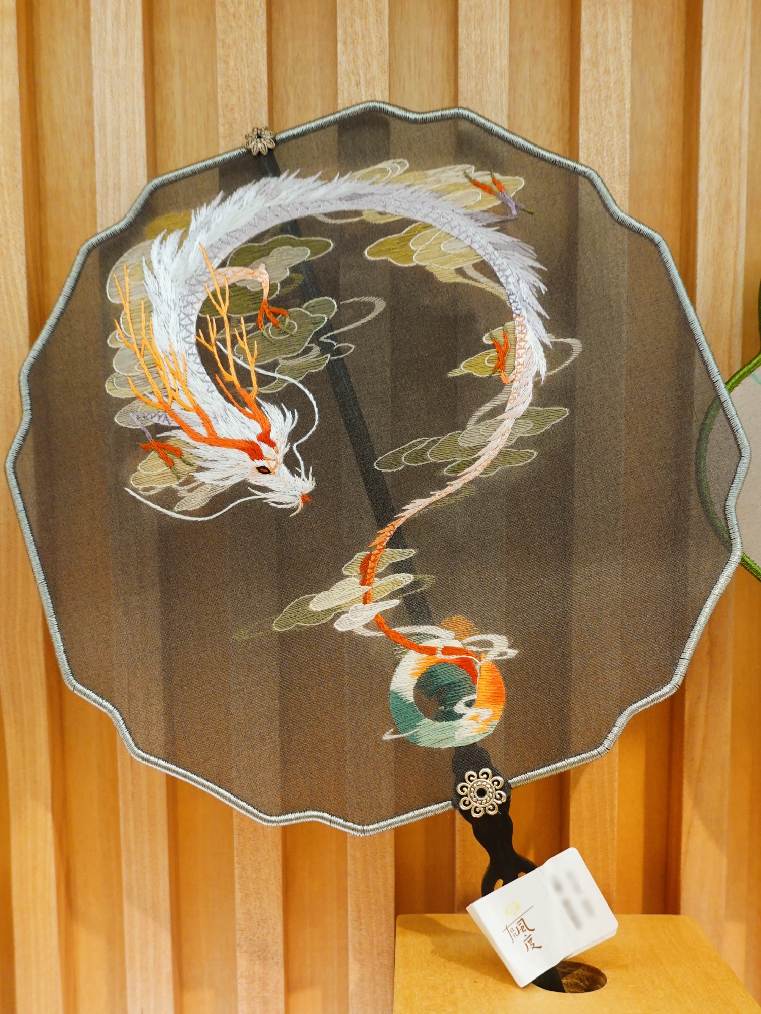 A silk fan featuring Suzhou embroidery is seen on display at Nianhuawan, a popular tourist town in Wuxi, Jiangsu Province, on July 21, 2024. /CGTN