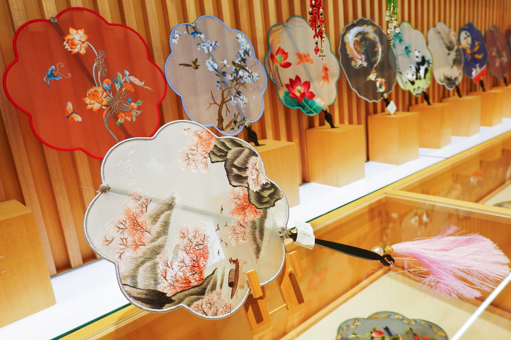 Silk embroidery fans are seen on display at Nianhuawan, a popular tourist town in Wuxi, Jiangsu Province, on July 21, 2024. /CGTN