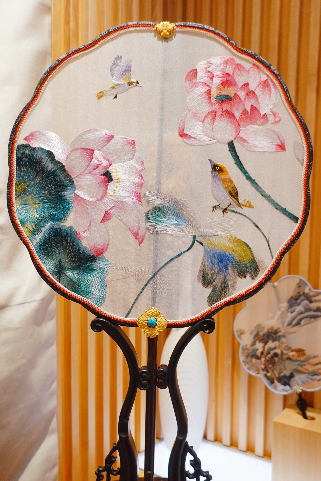 A silk fan featuring Suzhou embroidery is seen on display at Nianhuawan, a popular tourist town in Wuxi, Jiangsu Province, on July 21, 2024. /CGTN