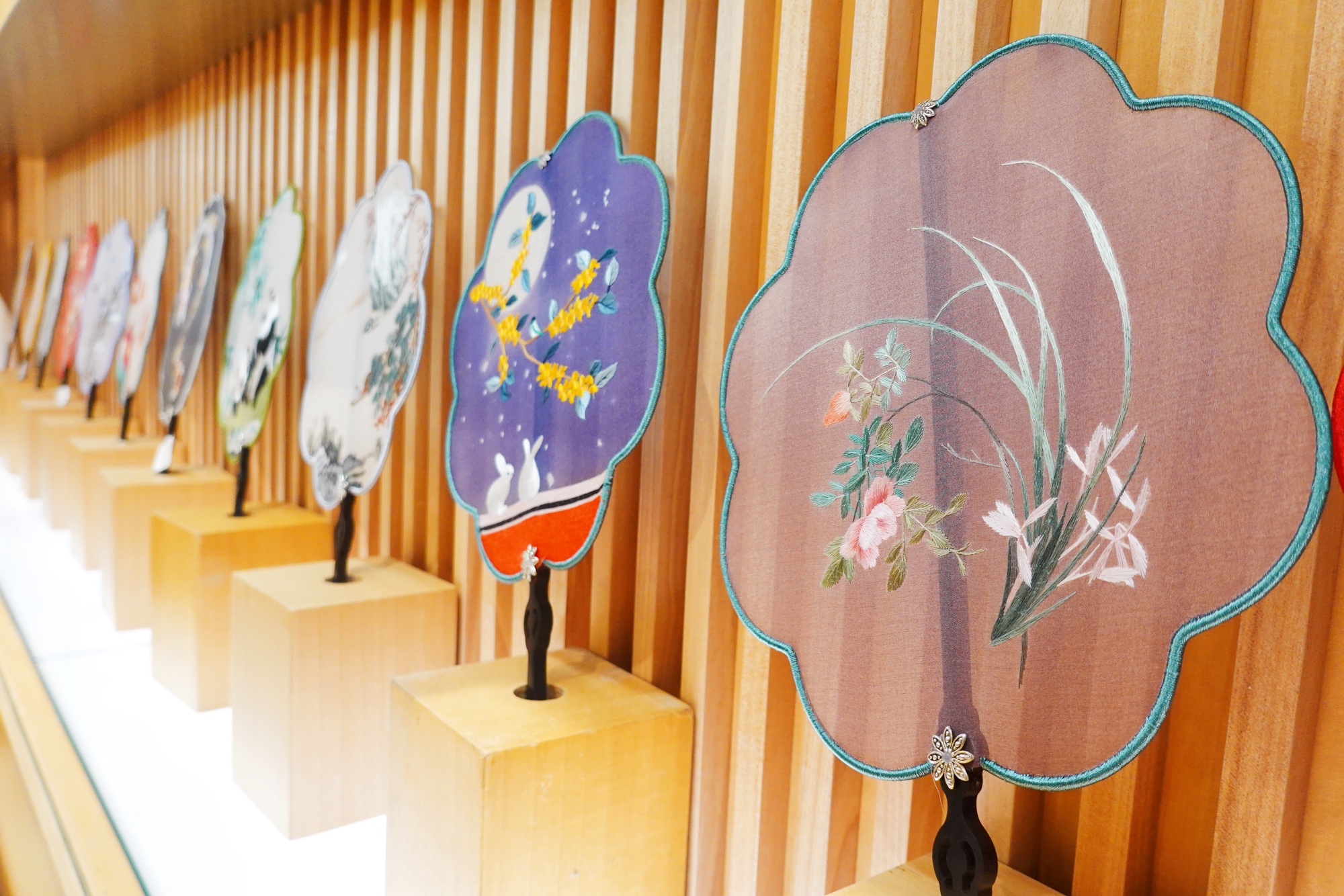 Silk embroidery fans are seen on display at Nianhuawan, a popular tourist town in Wuxi, Jiangsu Province, on July 21, 2024. /CGTN