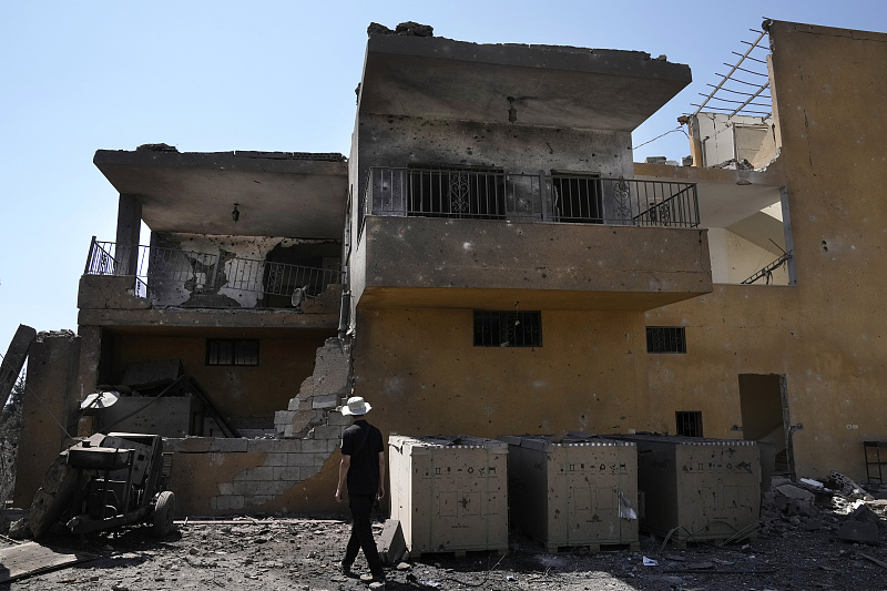 A man passes next of a damaged house that was hit by an Israeli airstrike in Nabi Sheet village, in Lebanon's eastern Bekaa Valley, August 21, 2024. /CFP