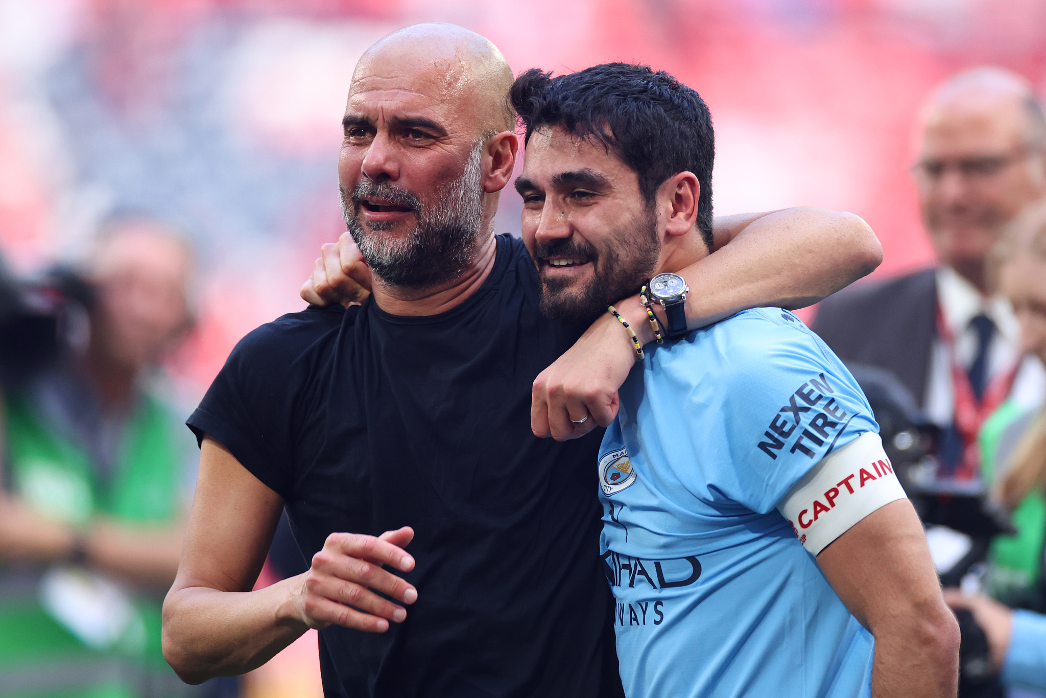 Ilkay Gundogan (R) of Manchester City and his manager Pep Guardiola celebrate the club's 2-1 win over Manchester United  in the FA Cup final at Wembley Stadium in London, England, June 3, 2023. /CFP 