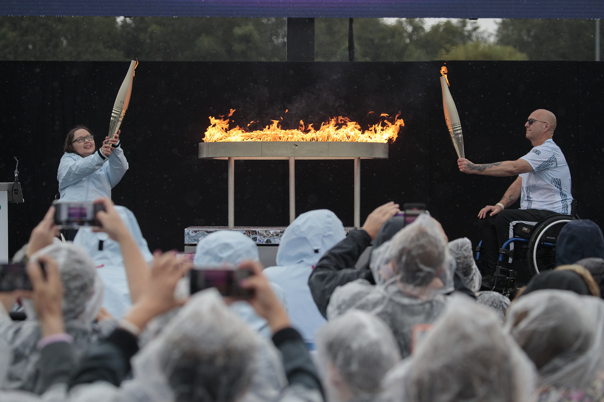 Participants hold up lit torches during the Paralympic Flame Lighting Ceremony at Stoke Mandeville Stadium in Aylesbury, England, August 24, 2024. /CFP