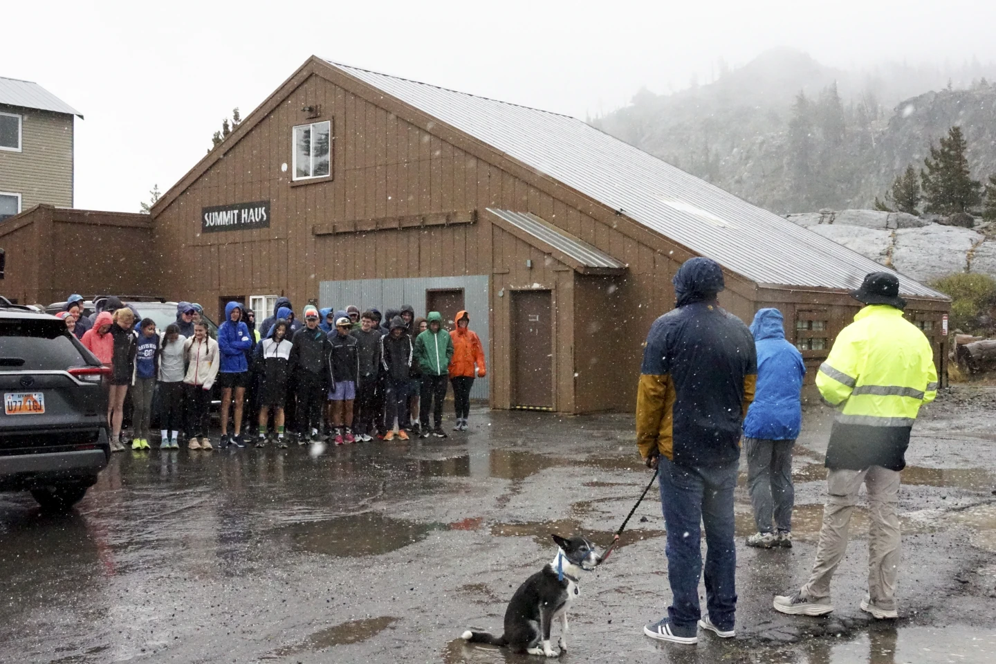 A group of cross-country athletes huddle together after their practice was canceled due to wet and snowy conditions in Donner Summit, California, U.S., August 24, 2024. /AP Photo/Brooke Hess-Homeier