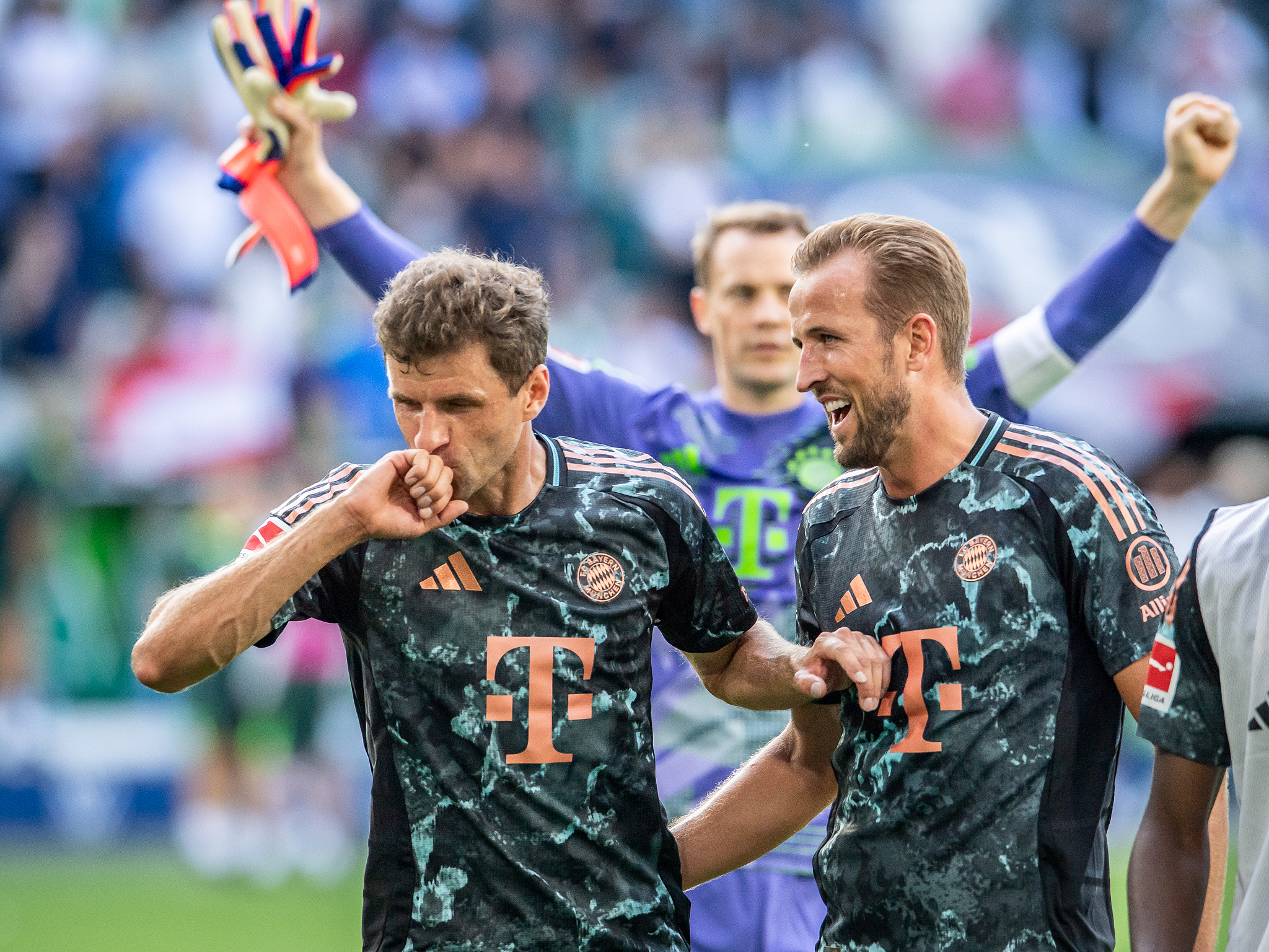 Thomas Müller (L) and Harry Kane of Bayern Munich celebrate their team's victory against Wolfsburg after a German Bundesliga match at the Volkswagen Arena in Wolfsburg, Germany, August 25, 2024. /CFP