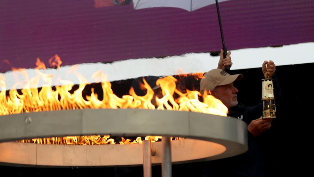 Officials light a lantern from the cauldron during the Paralympic Torch-Lighting Ceremony for the Paris 2024 Paralympic Games at Stoke Mandeville, Britain, August 24, 2024. /Xinhua