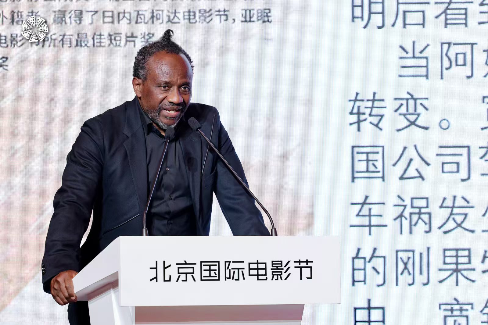 Film director Joseph Kumbela is seen in a file photo speaking at a conference in Beijing. /BJIFF