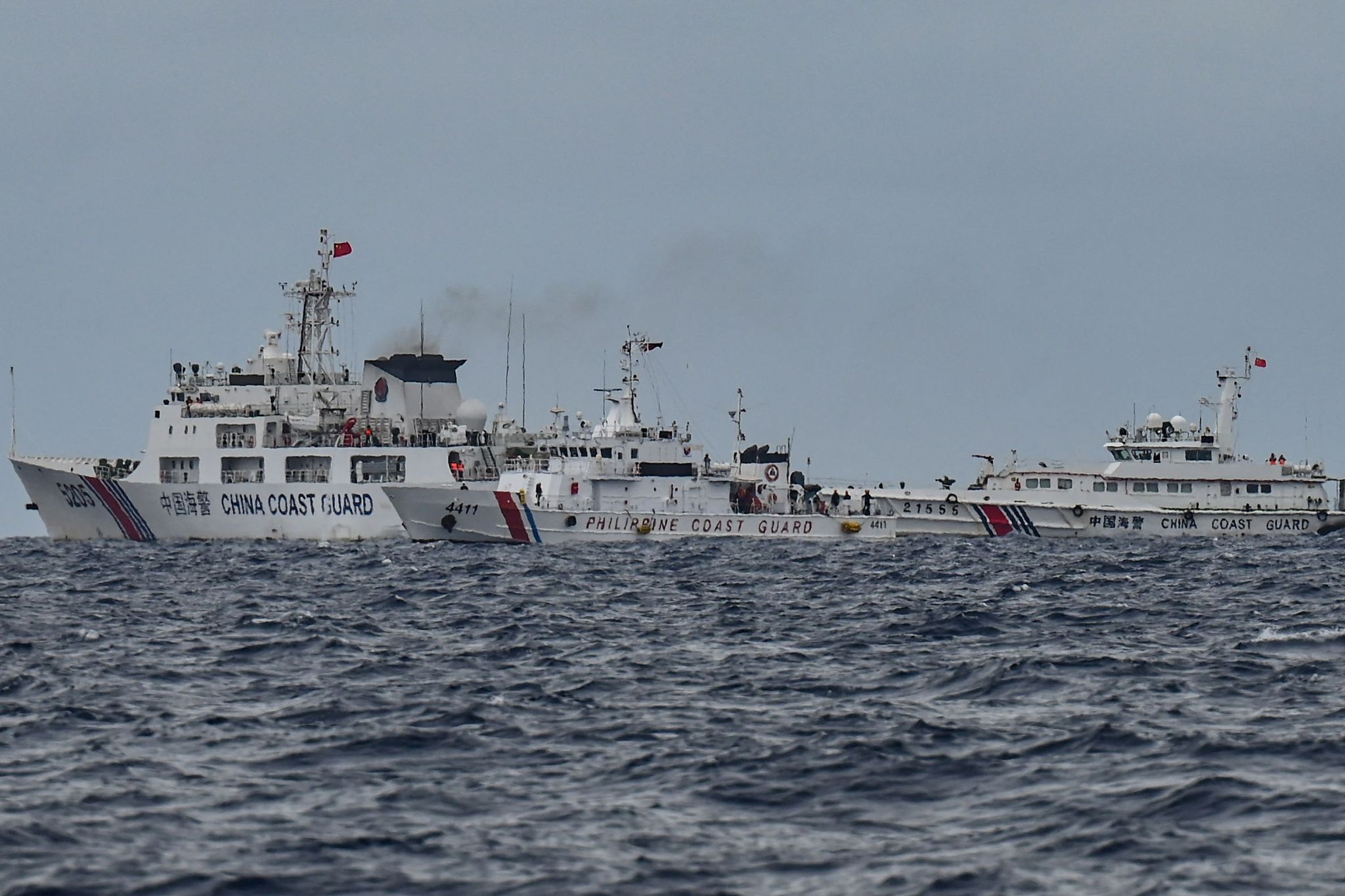 A Philippine Coast Guard ship approaches China Coast Guard ships (background L&R) that were navigating normally in waters adjacent to China's Xianbin Jiao in the Nansha Qundao, August 26, 2024. /CFP